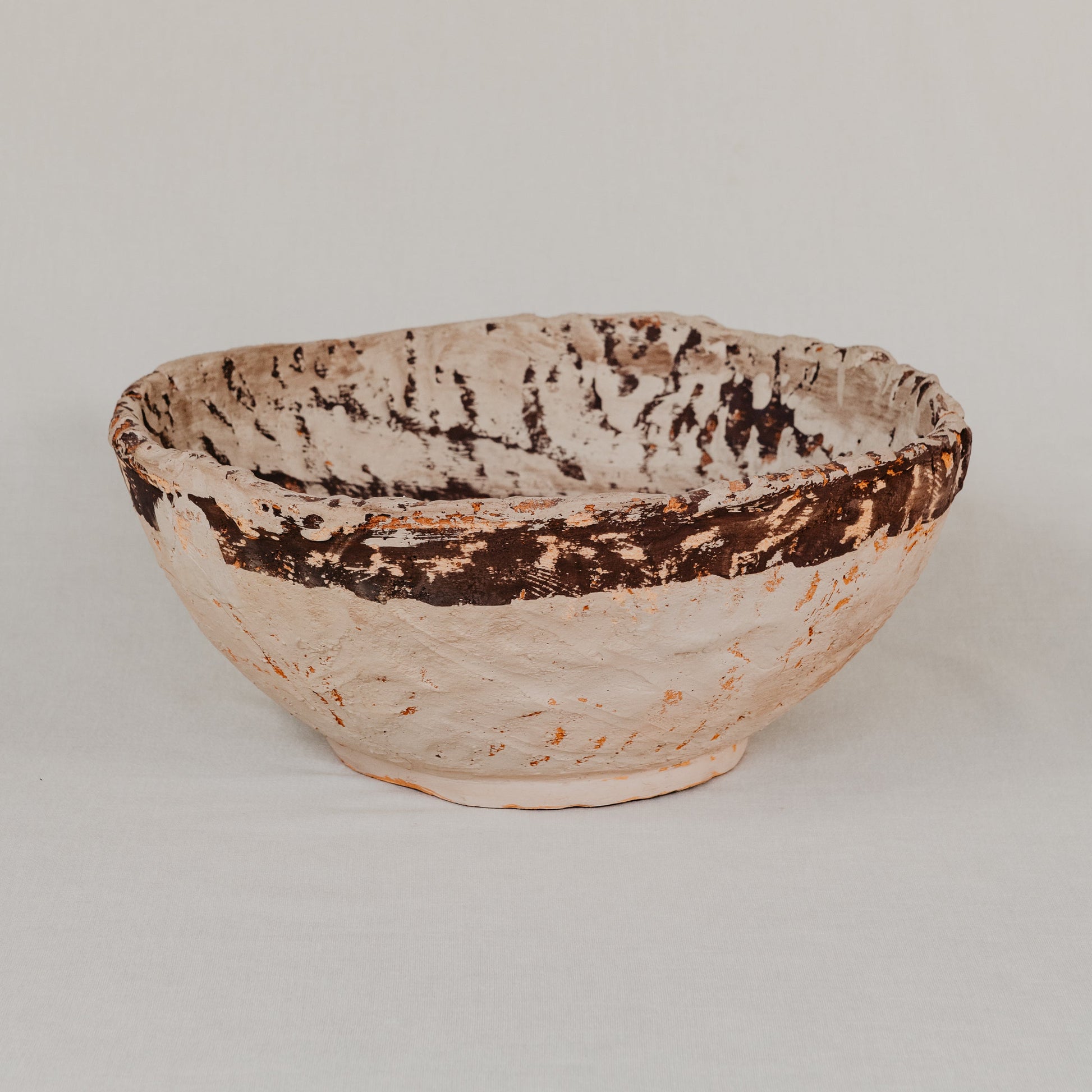 Ceramic bowl with textured surface on a light gray background