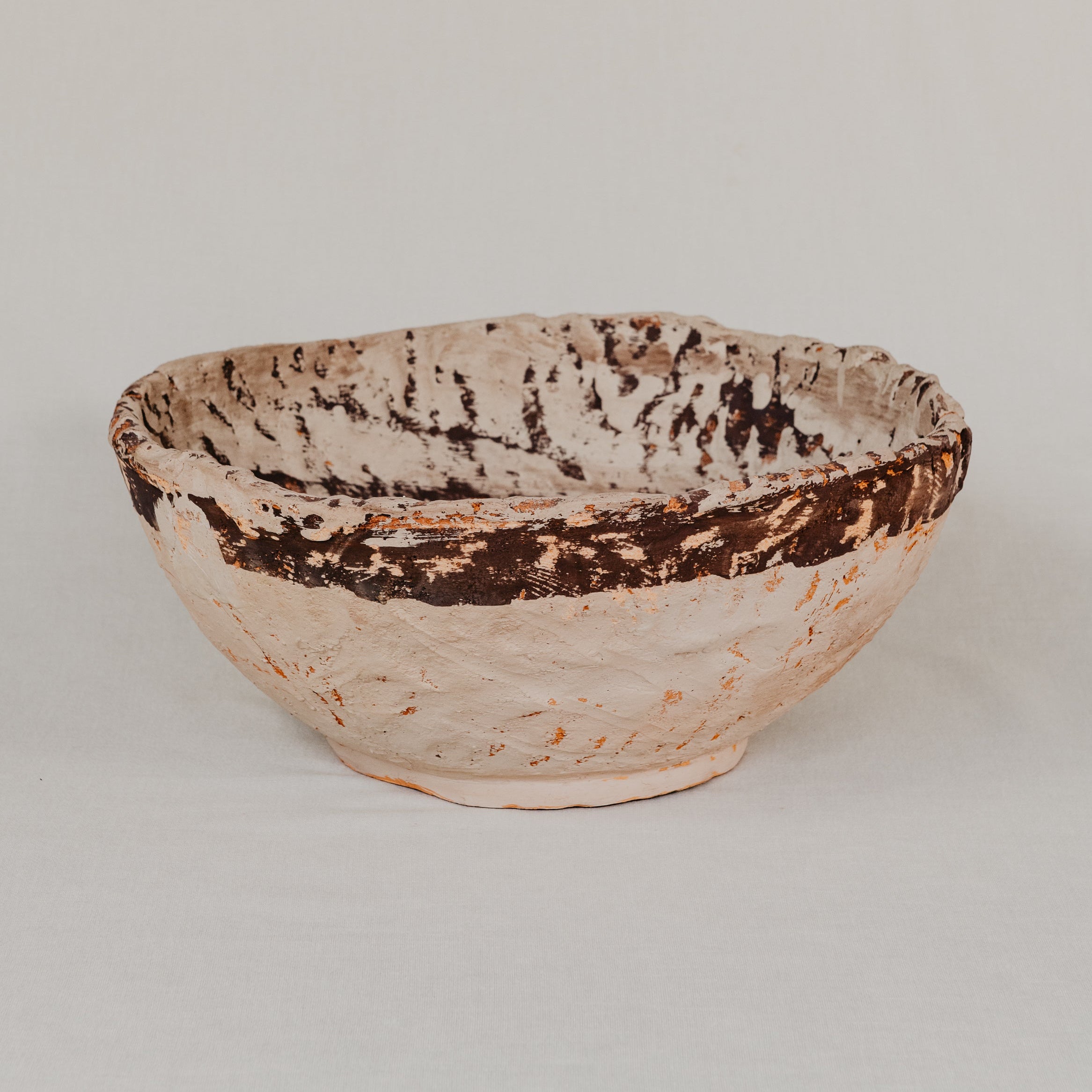Ceramic bowl with textured surface on a light gray background