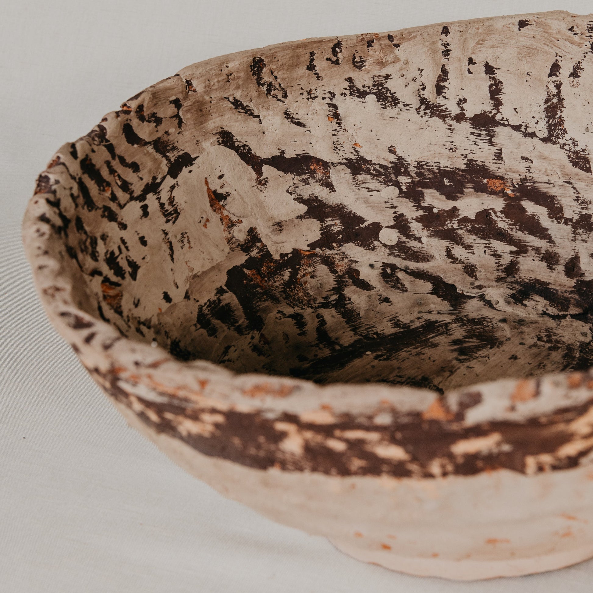 Ceramic bowl with textured surface on a neutral background
