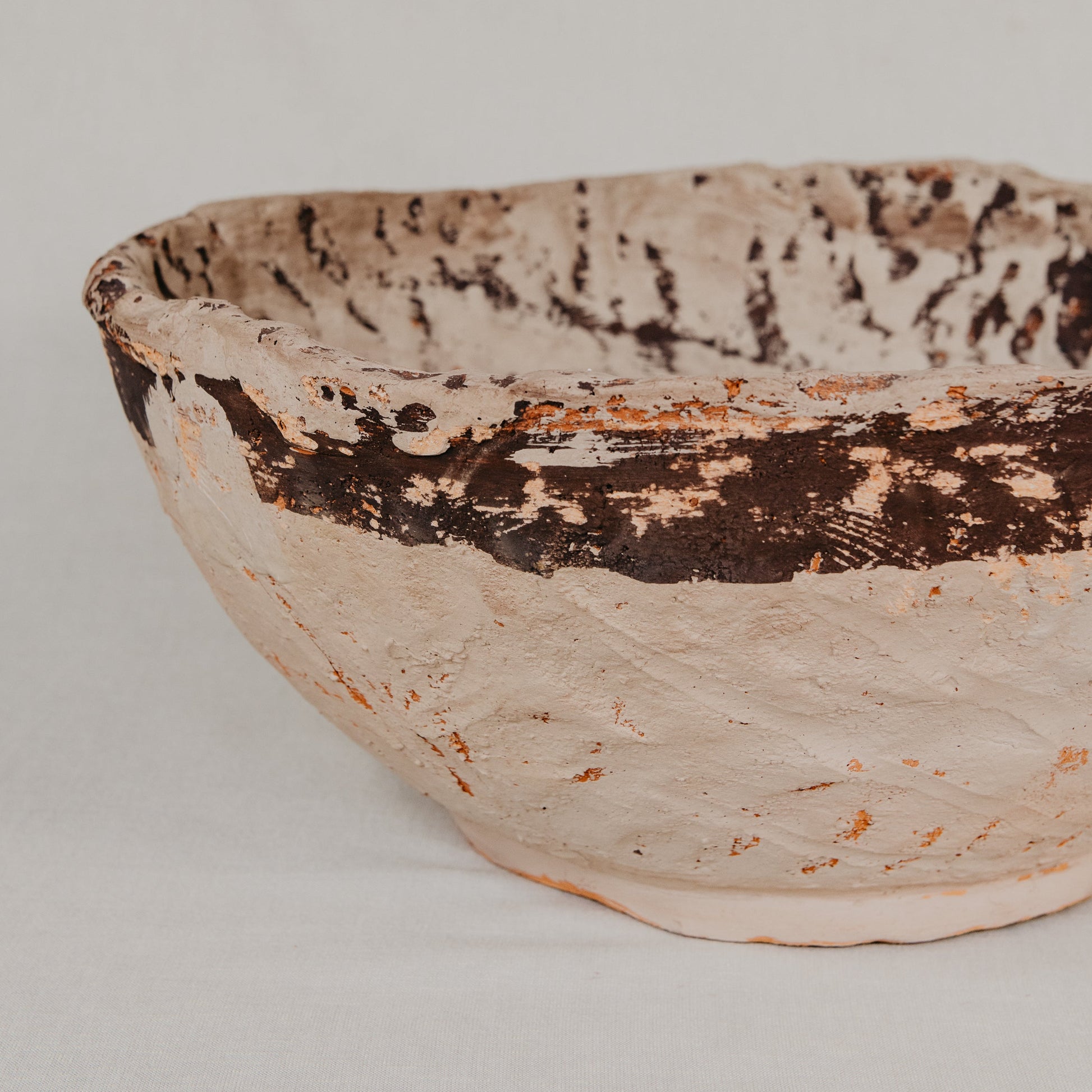 Ceramic bowl with textured surface on a plain background