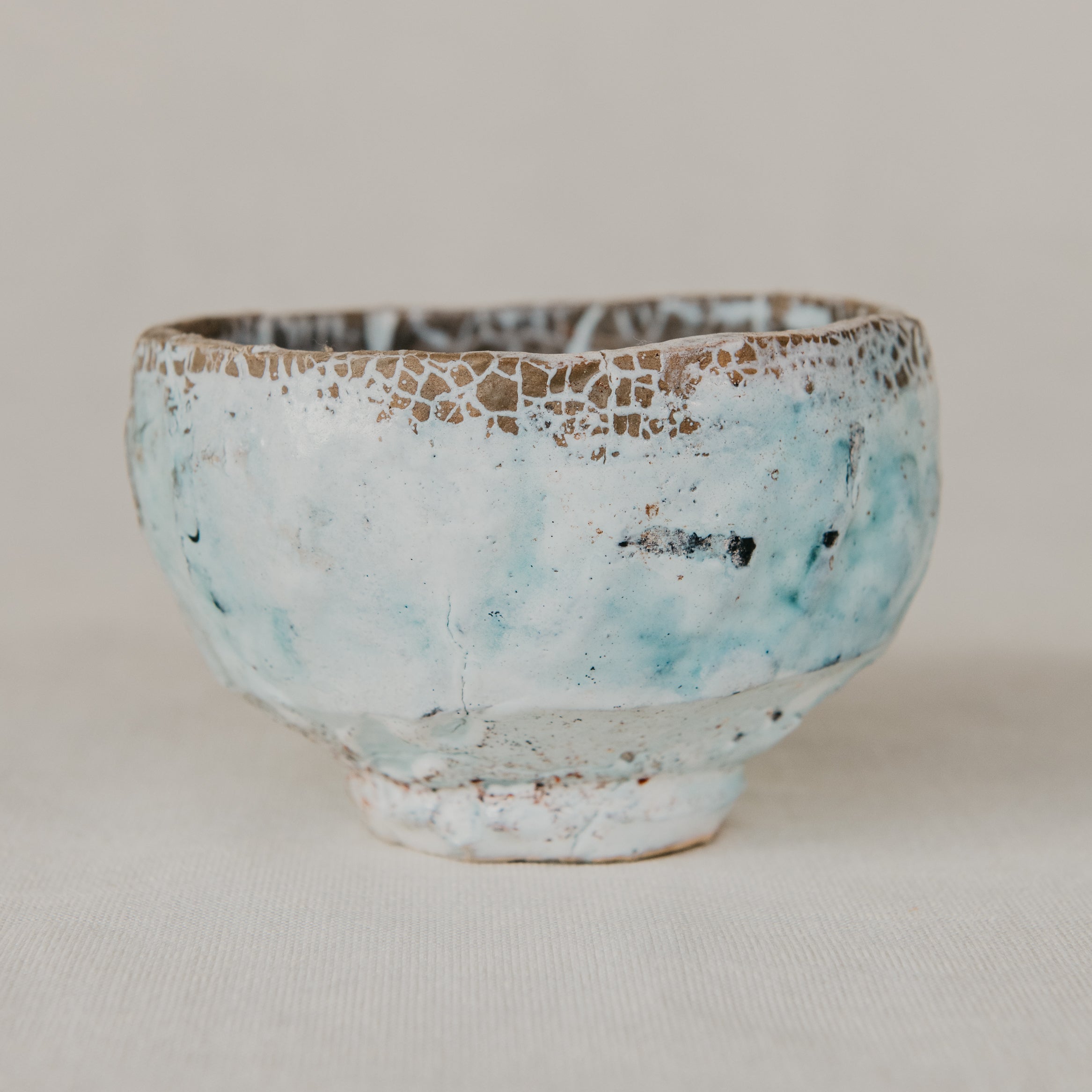 Ceramic bowl with textured surface on a plain background