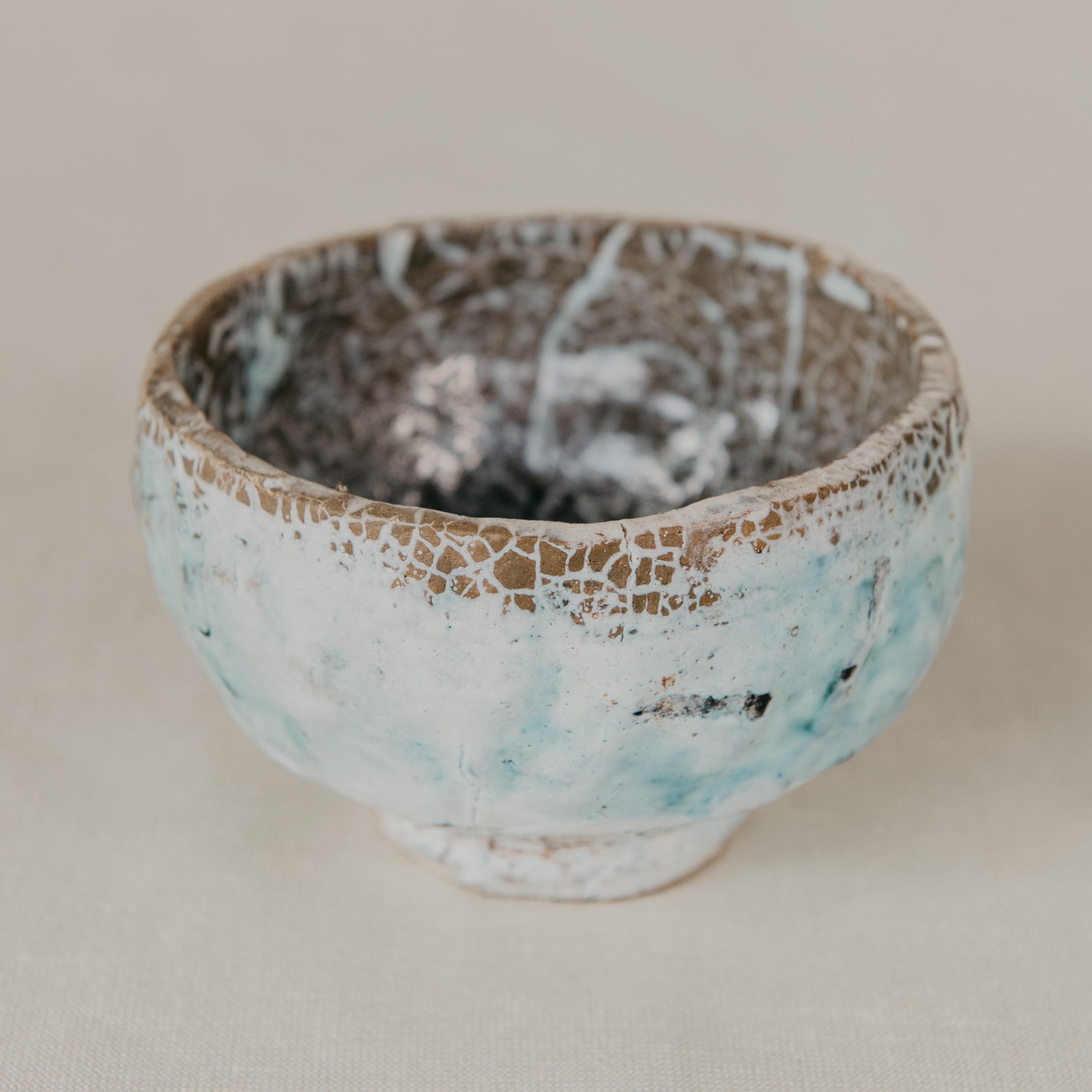 Small ceramic bowl with textured surface on a plain background