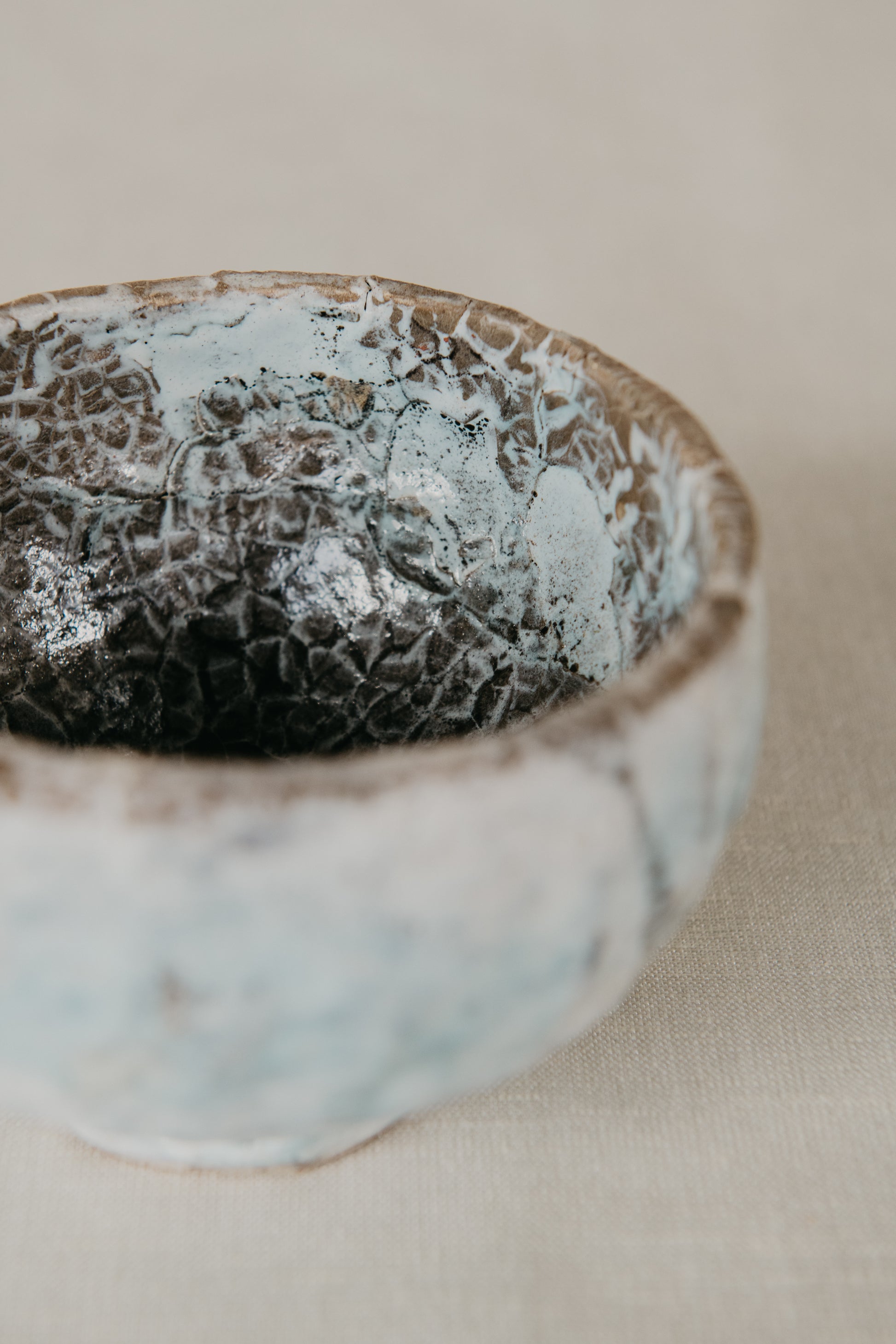 Ceramic bowl with textured surface on a neutral background