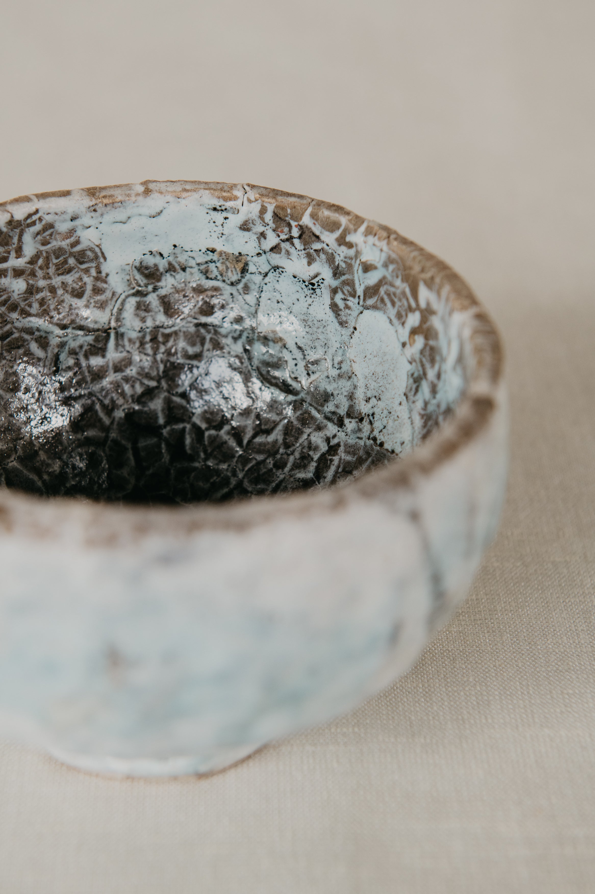 Ceramic bowl with textured surface on a neutral background
