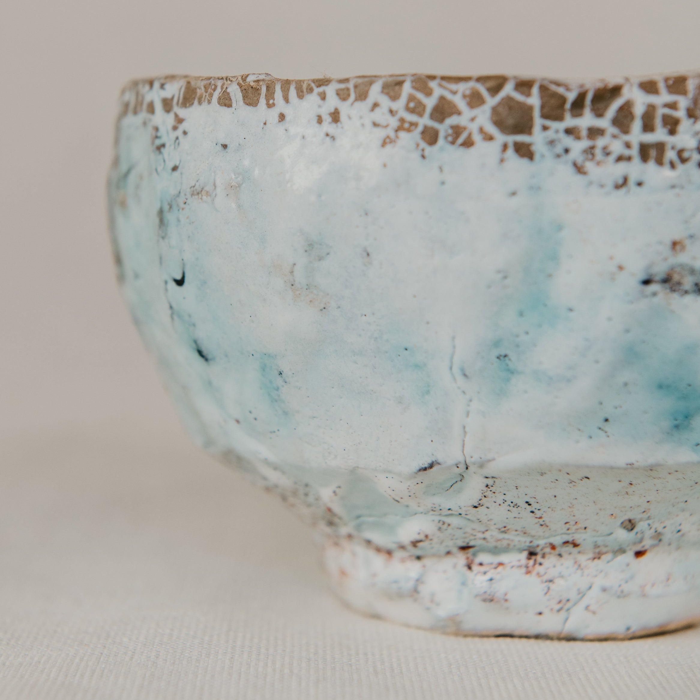 Close-up of a ceramic bowl with textured surface on a light background