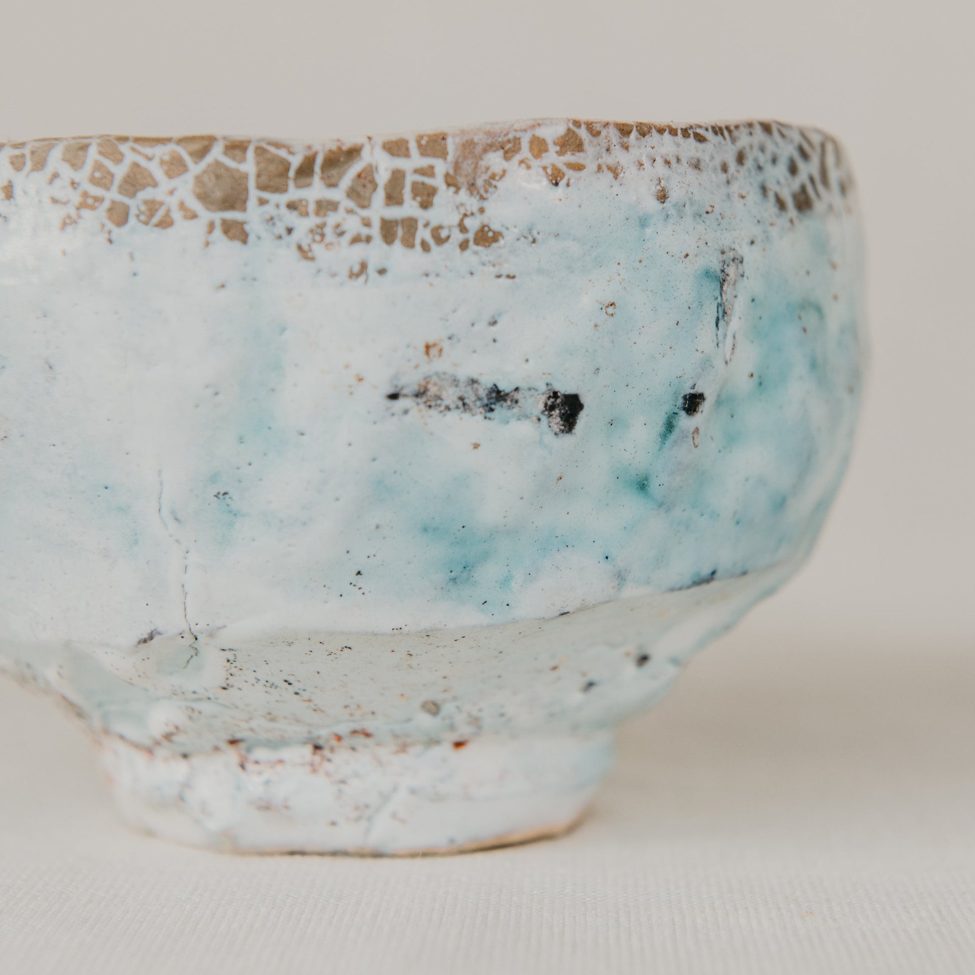 Ceramic bowl with textured surface on a plain background