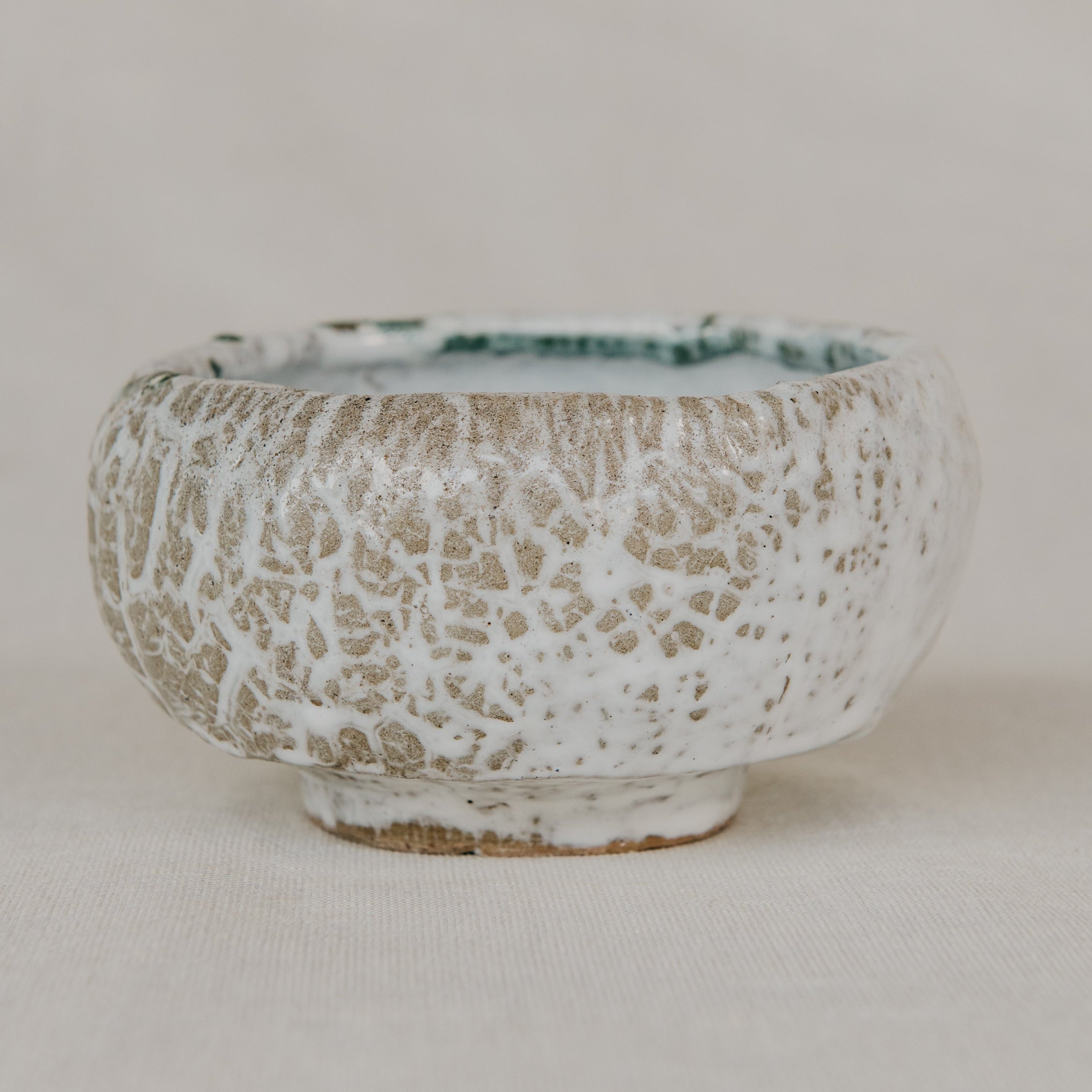 Ceramic bowl with textured surface on a plain background