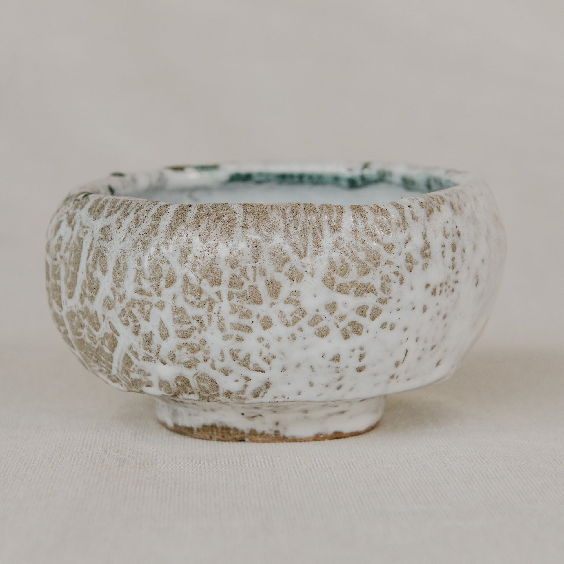 Ceramic bowl with textured surface on a plain background