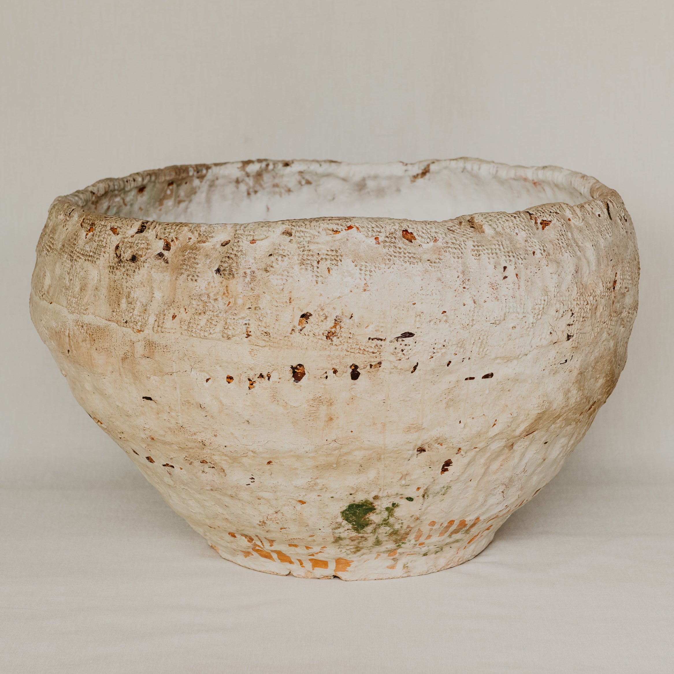 Textured ceramic bowl on a plain background