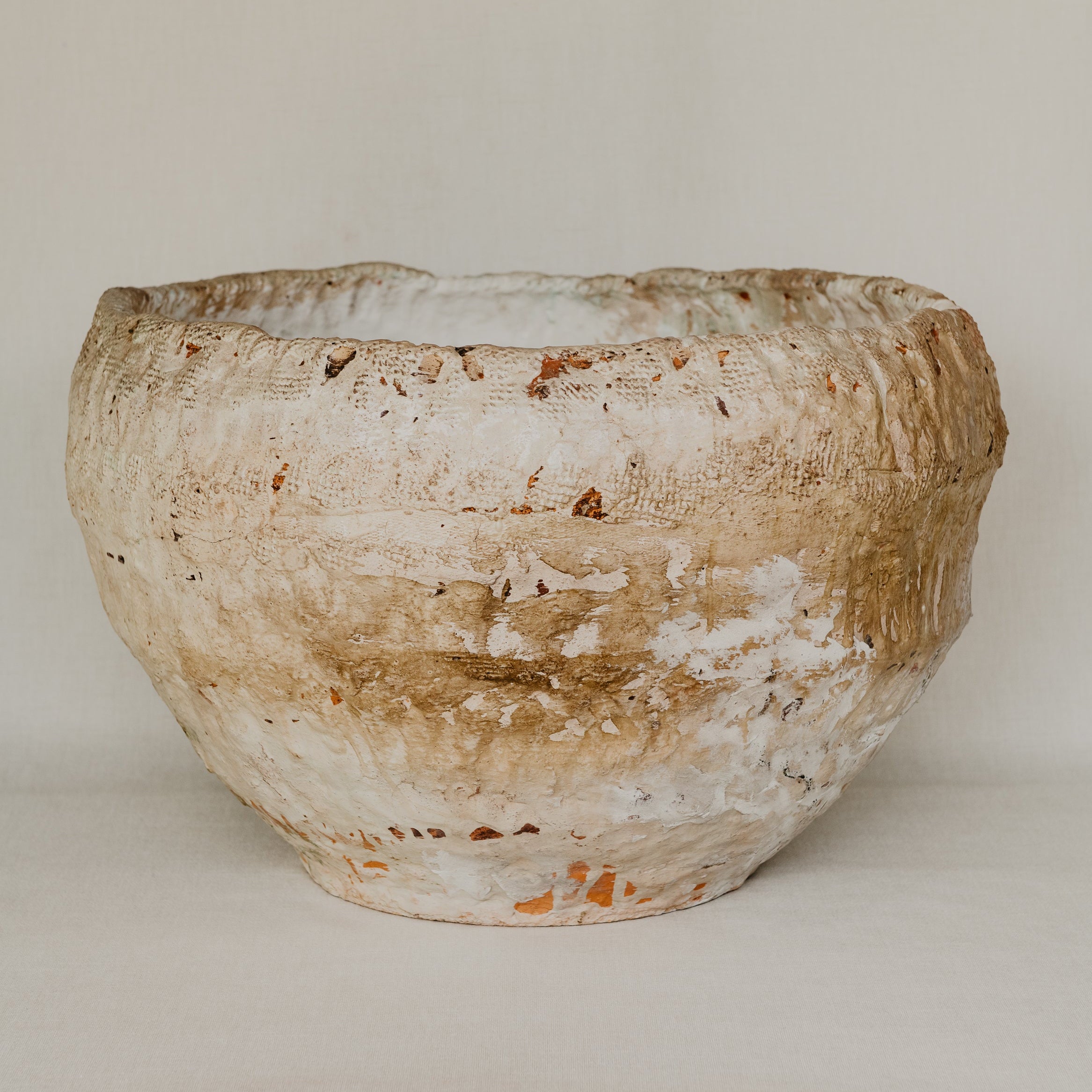 Vintage ceramic bowl with a textured surface on a plain background