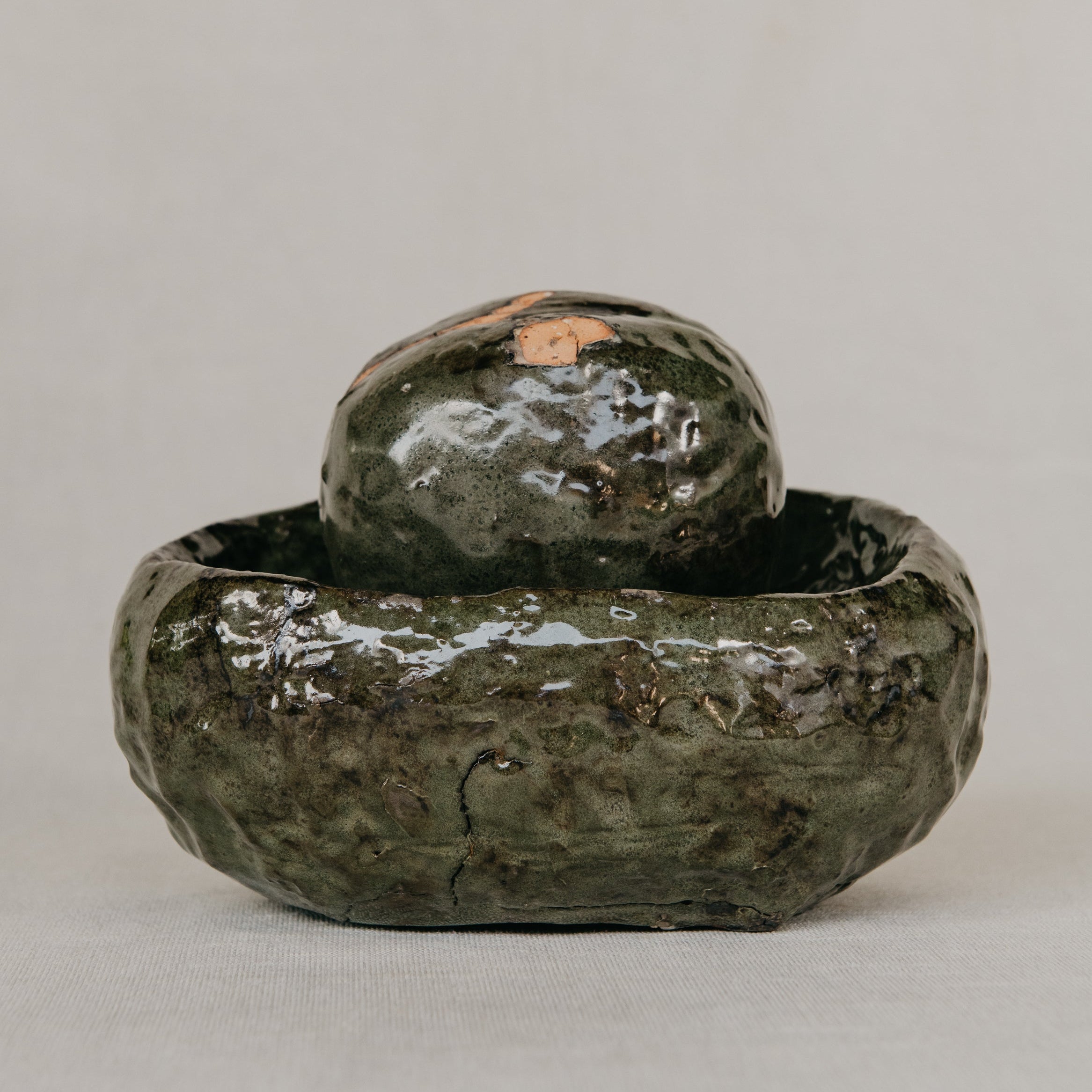 Green ceramic object on a gray background