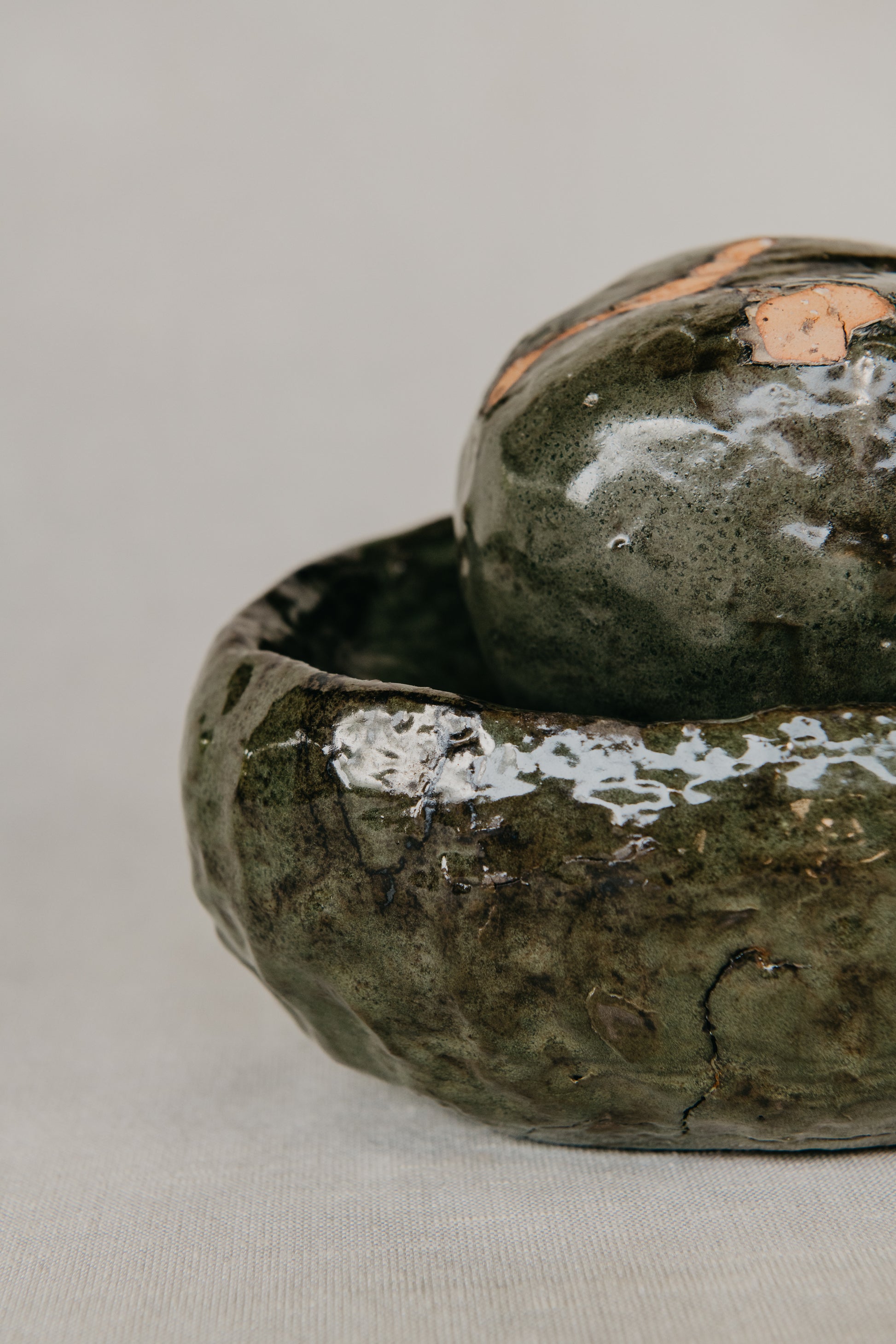 Two green ceramic bowls on a light gray background