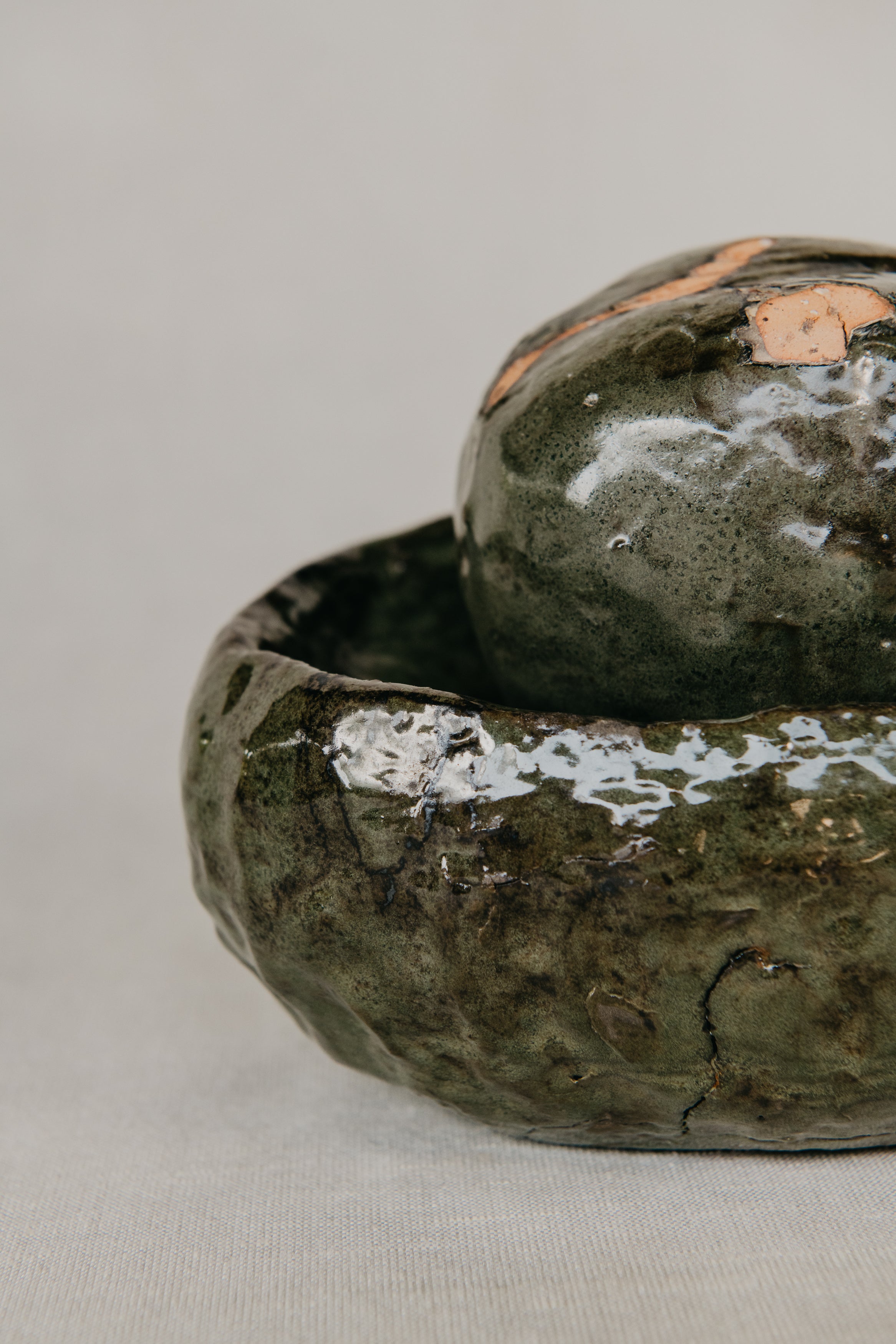 Two green ceramic bowls on a light gray background