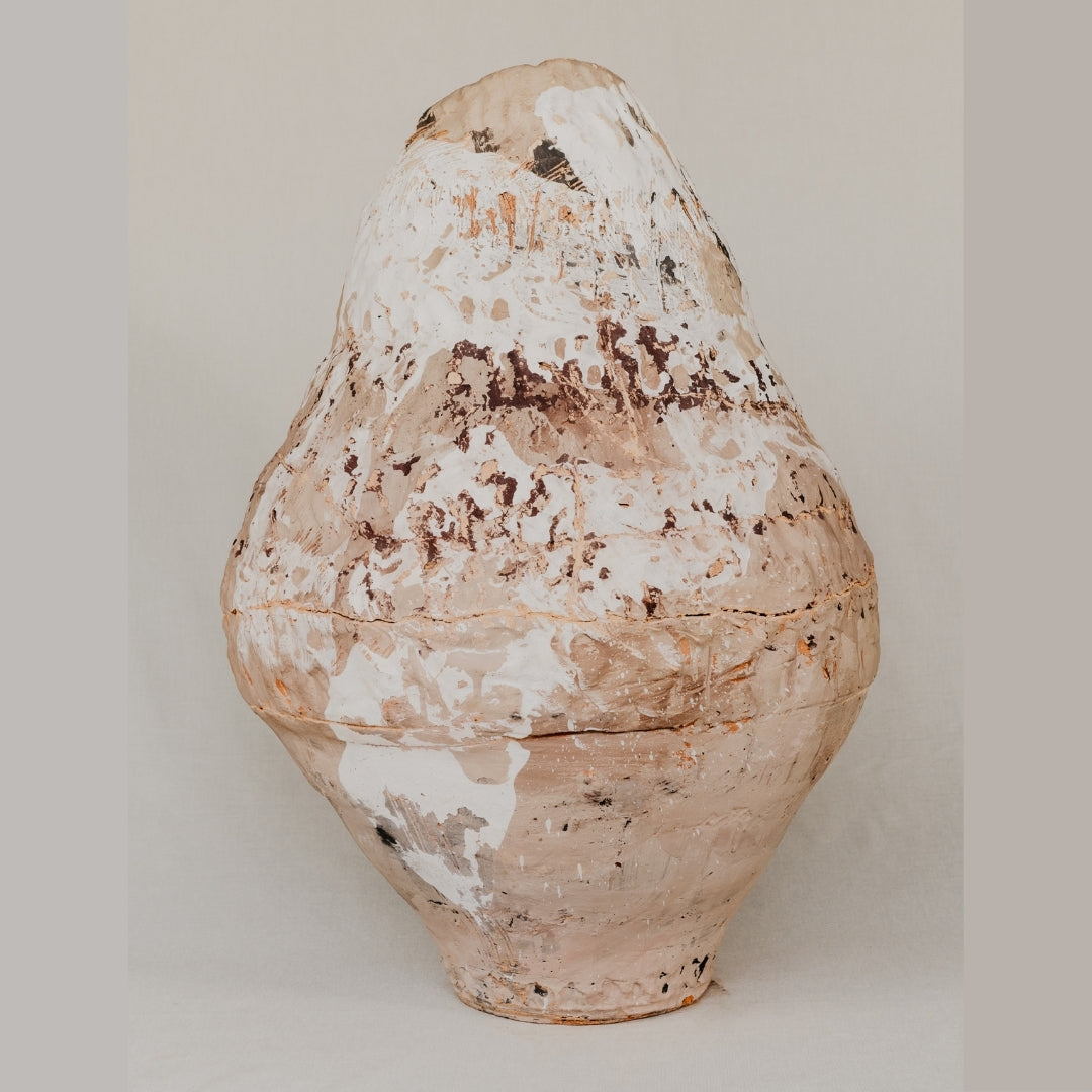 Vintage terracotta pot with a textured surface on a plain background