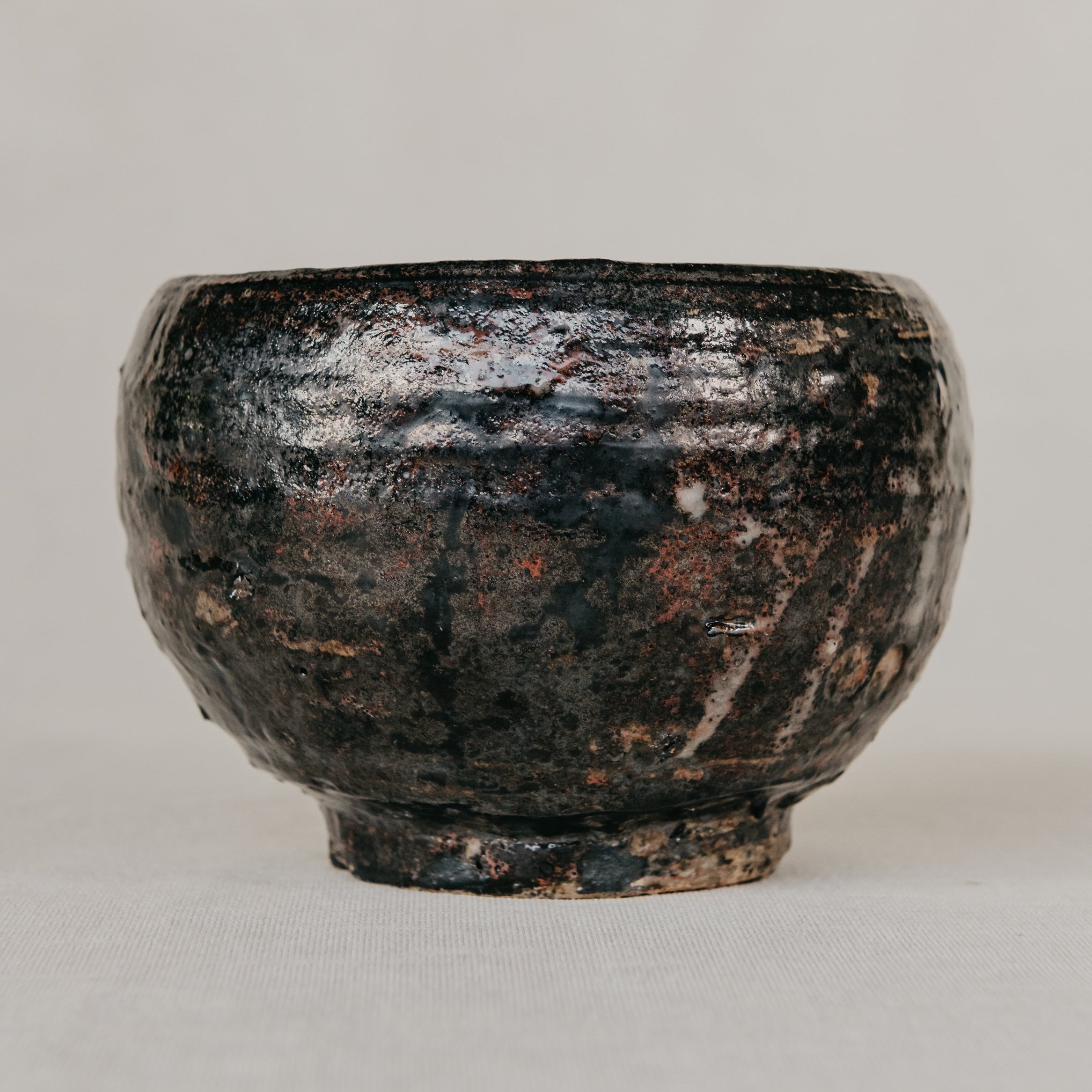 Black ceramic bowl on a light gray background