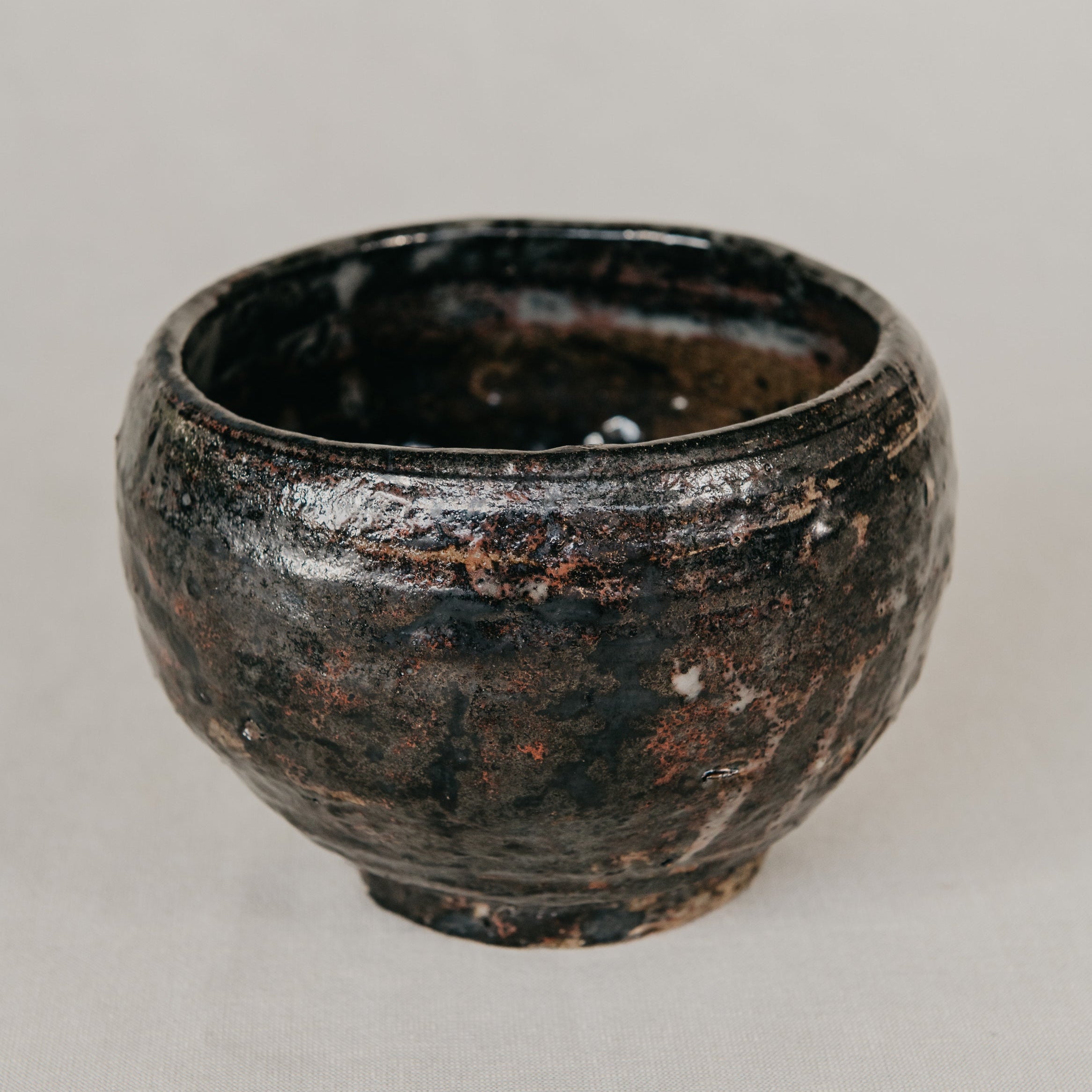 Black ceramic bowl on a light gray background
