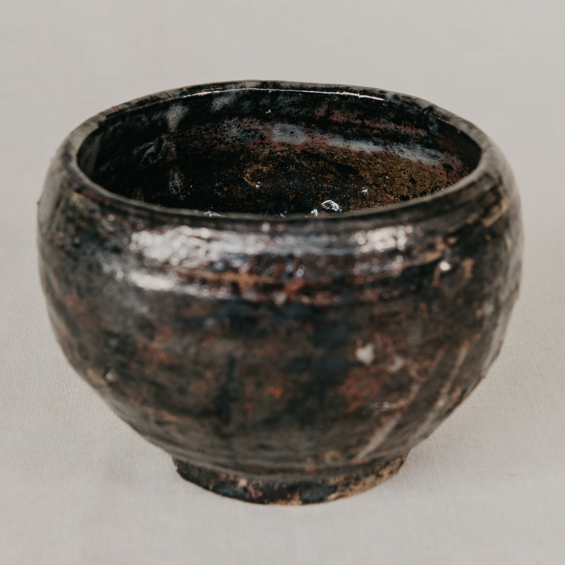 Black ceramic bowl on a light gray background