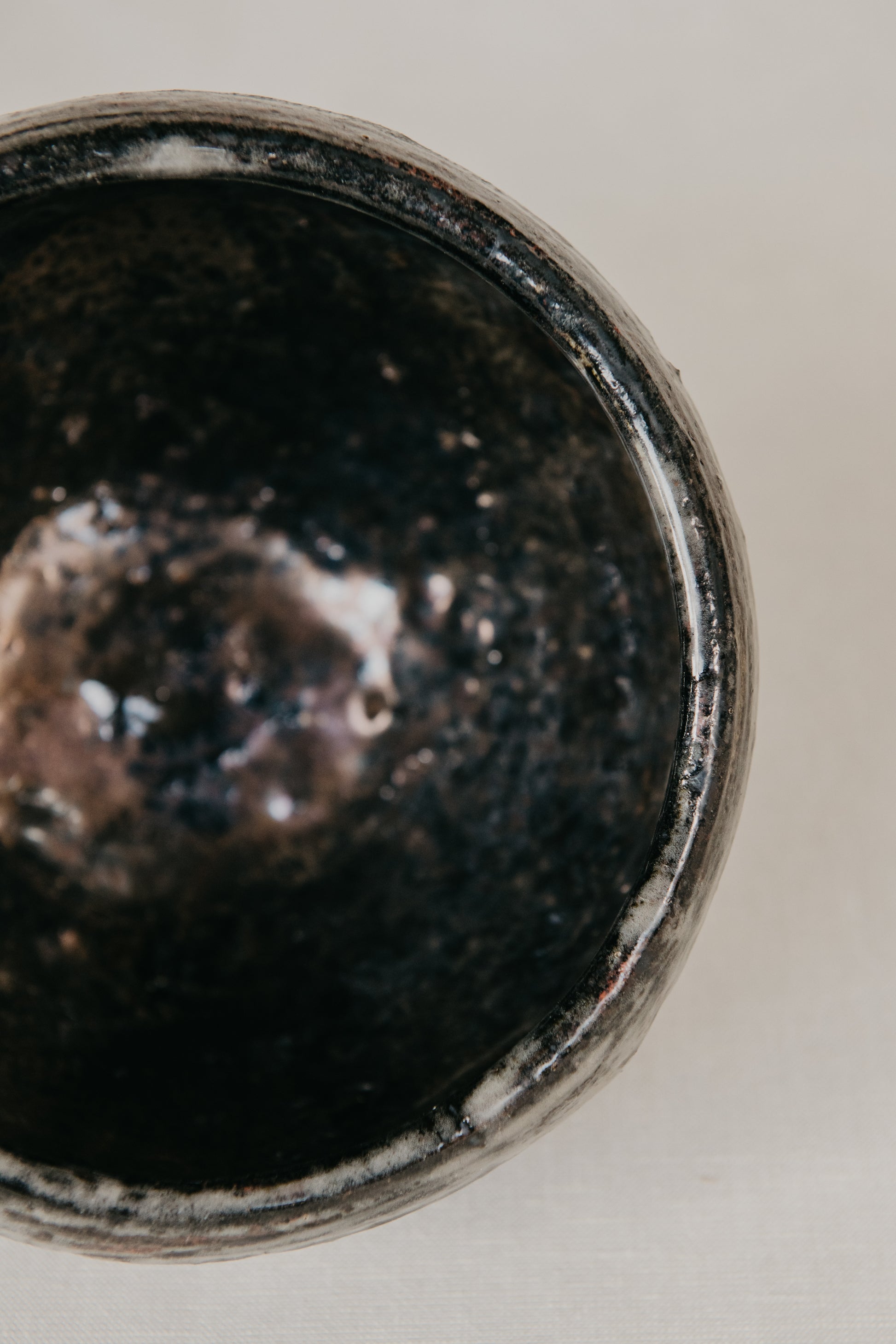 Close-up of a dark ceramic bowl on a light background