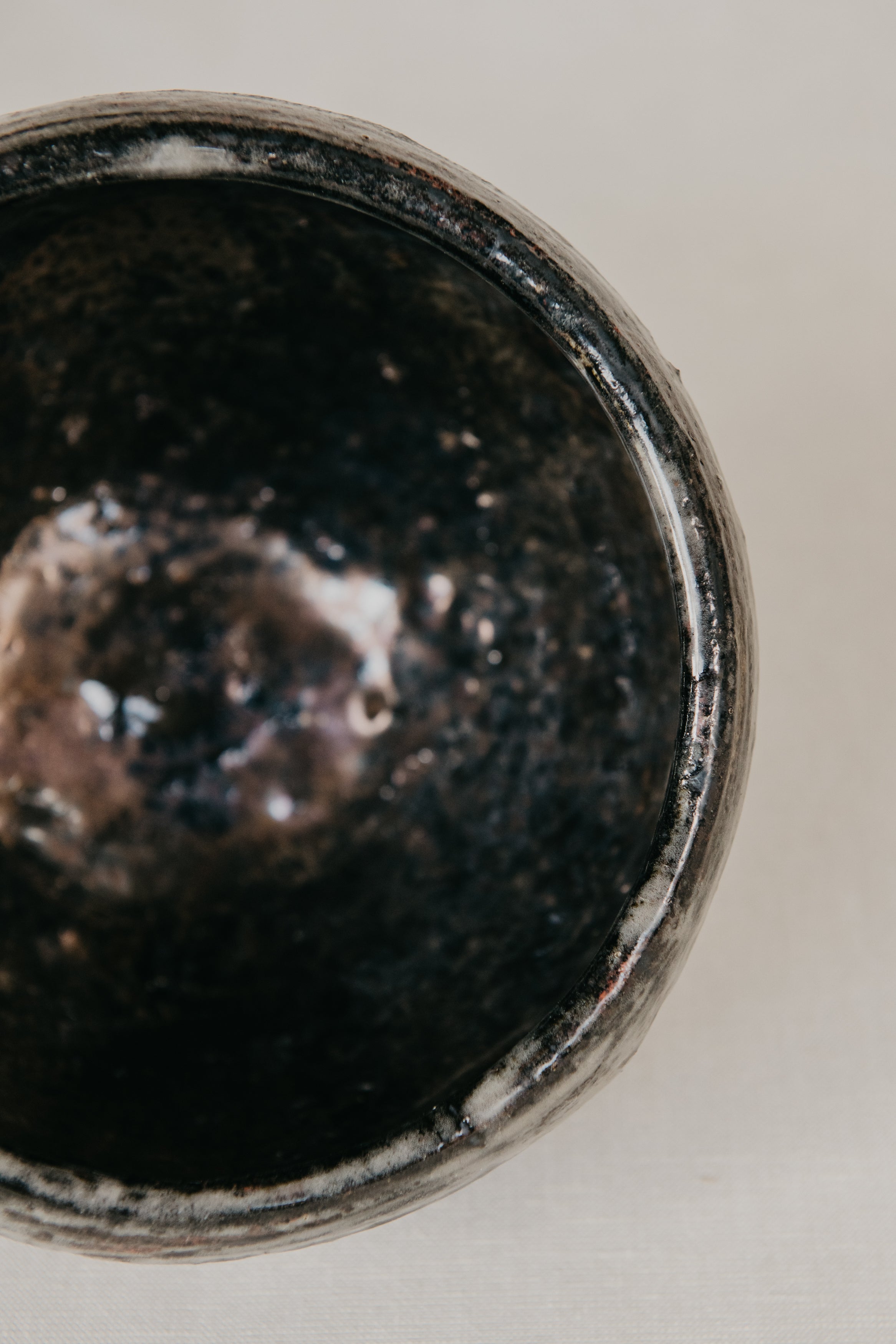 Close-up of a dark ceramic bowl on a light background