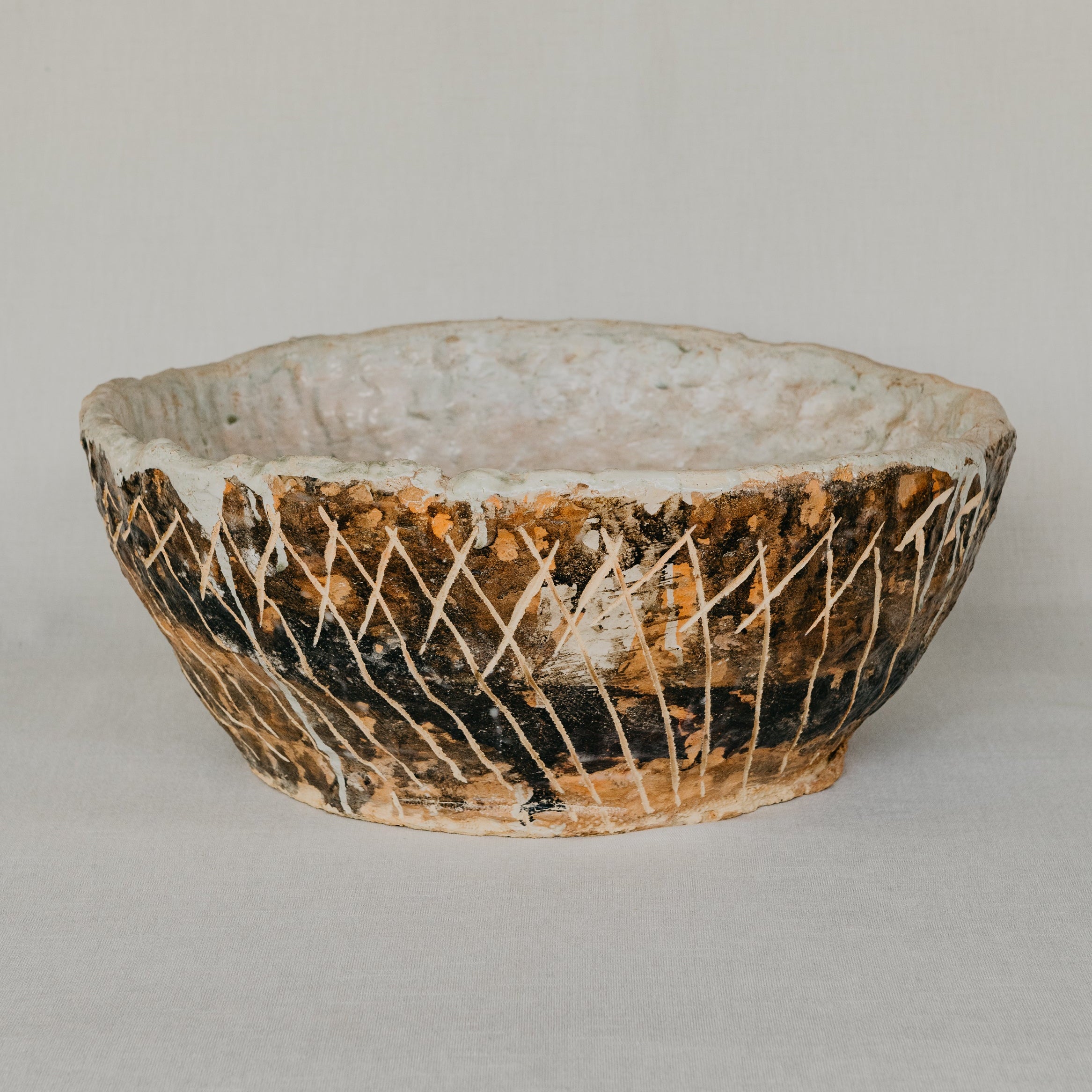 Ceramic bowl with textured surface on a plain background
