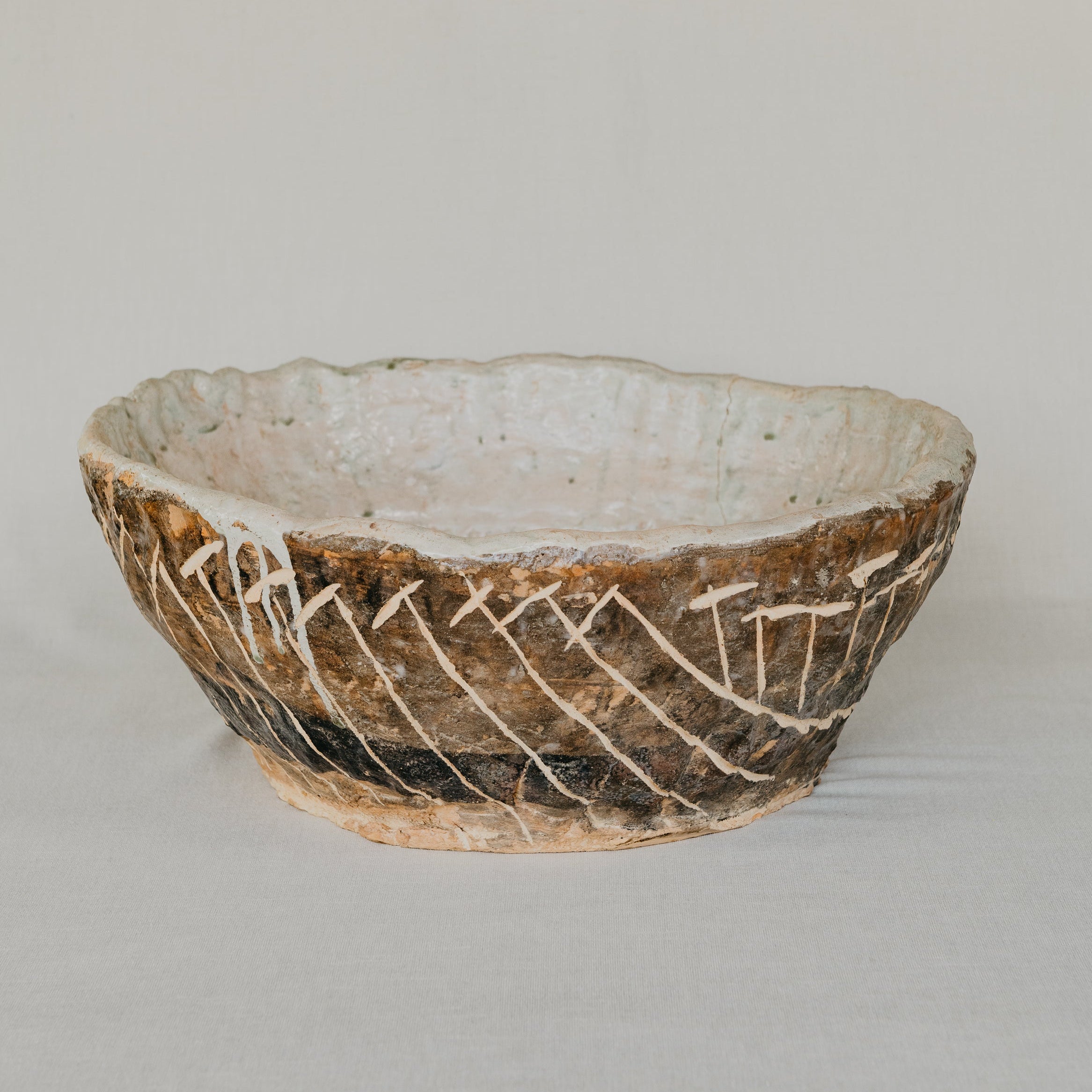 Ceramic bowl with textured surface on a plain background