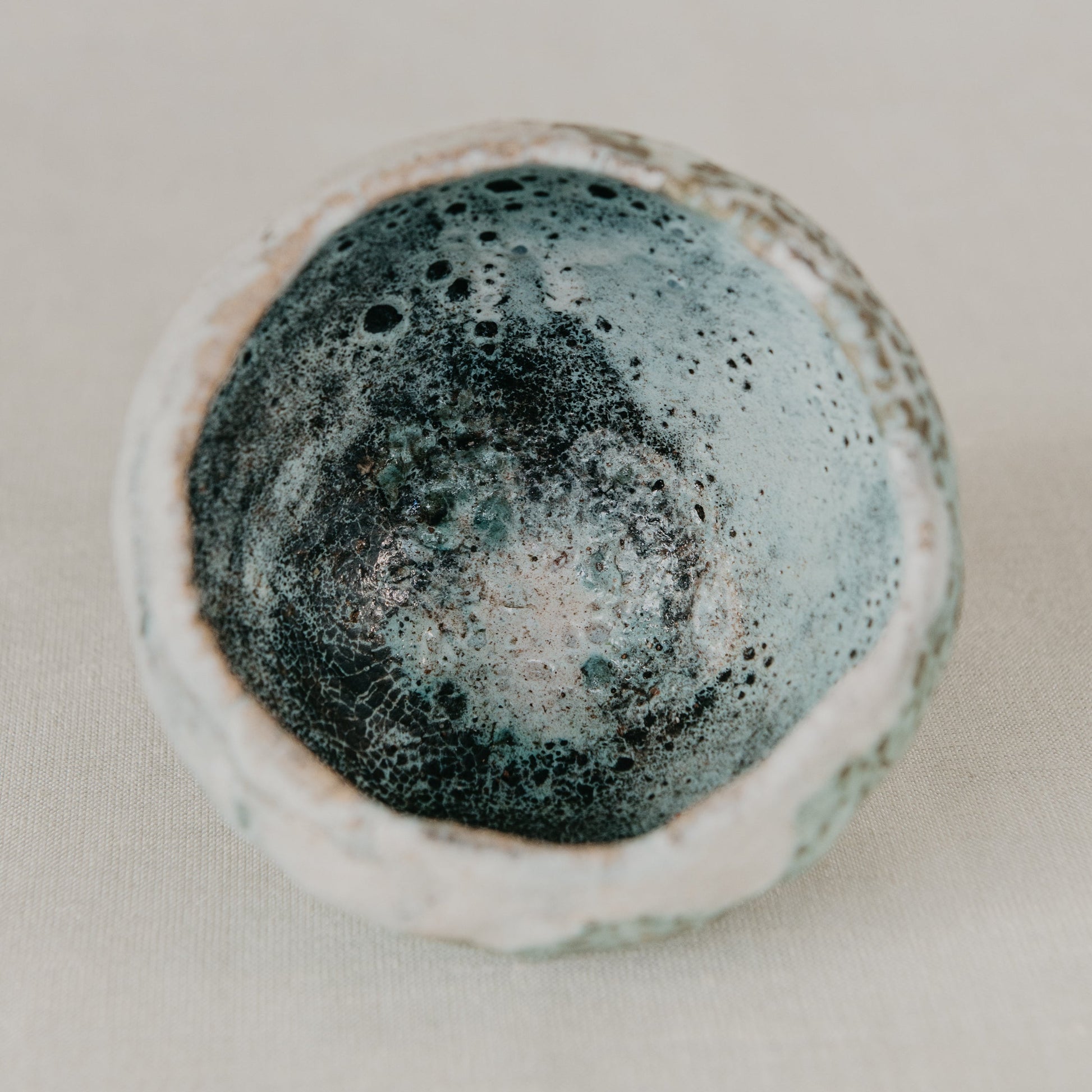 Ceramic bowl with textured surface on a neutral background