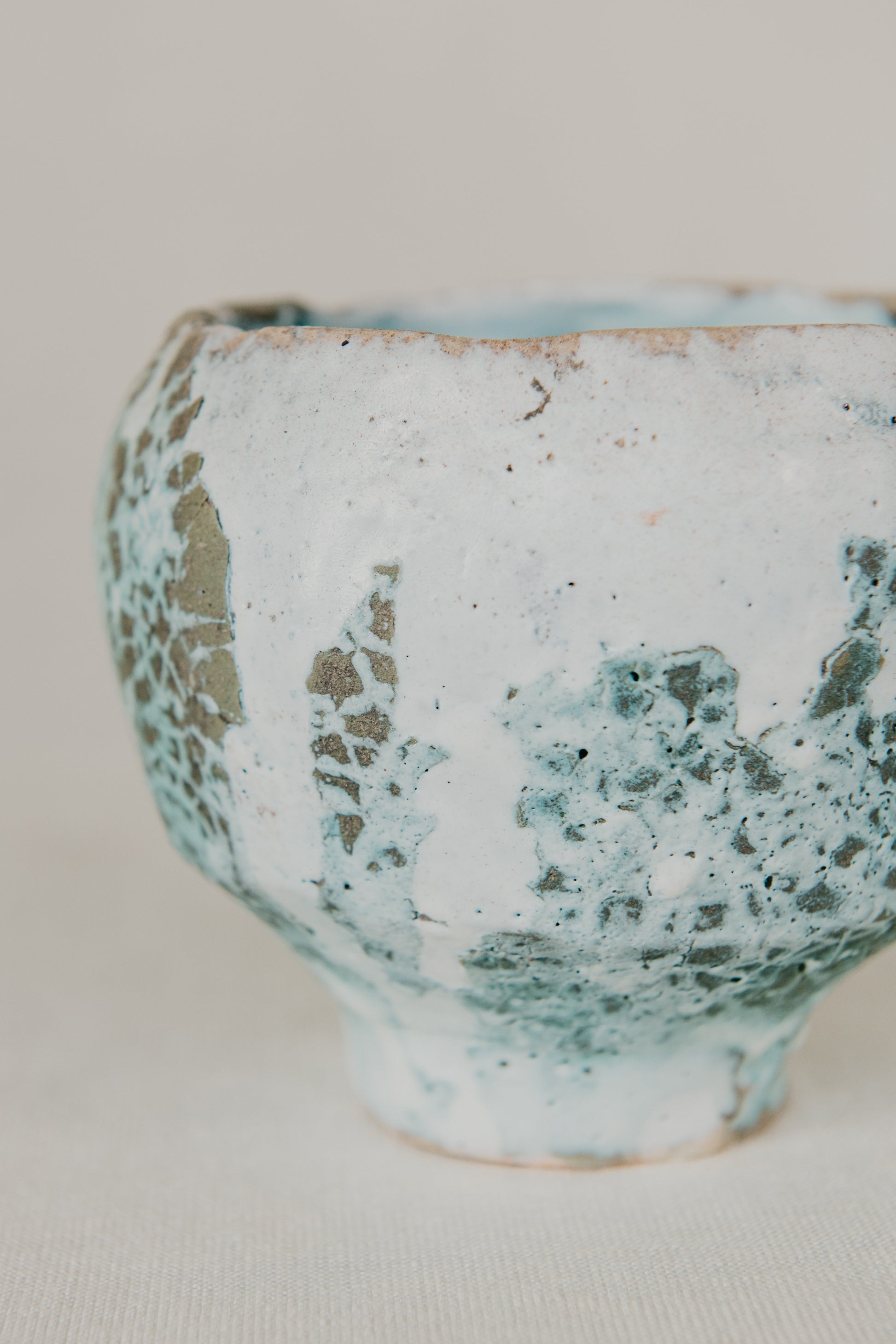 Ceramic vase with textured surface on a plain background