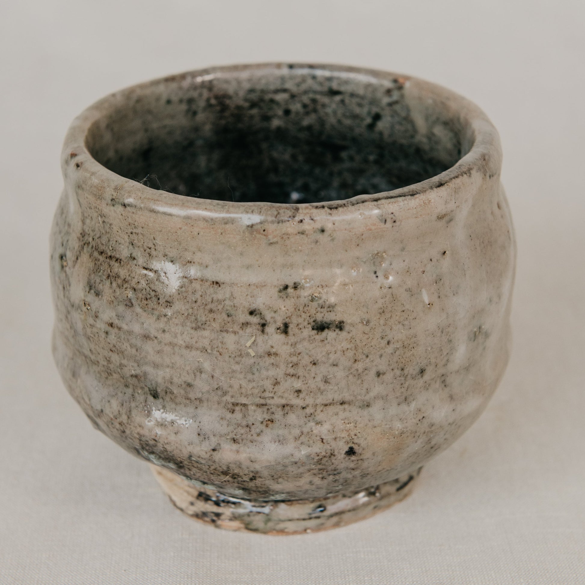 Ceramic cup with a textured surface on a plain background