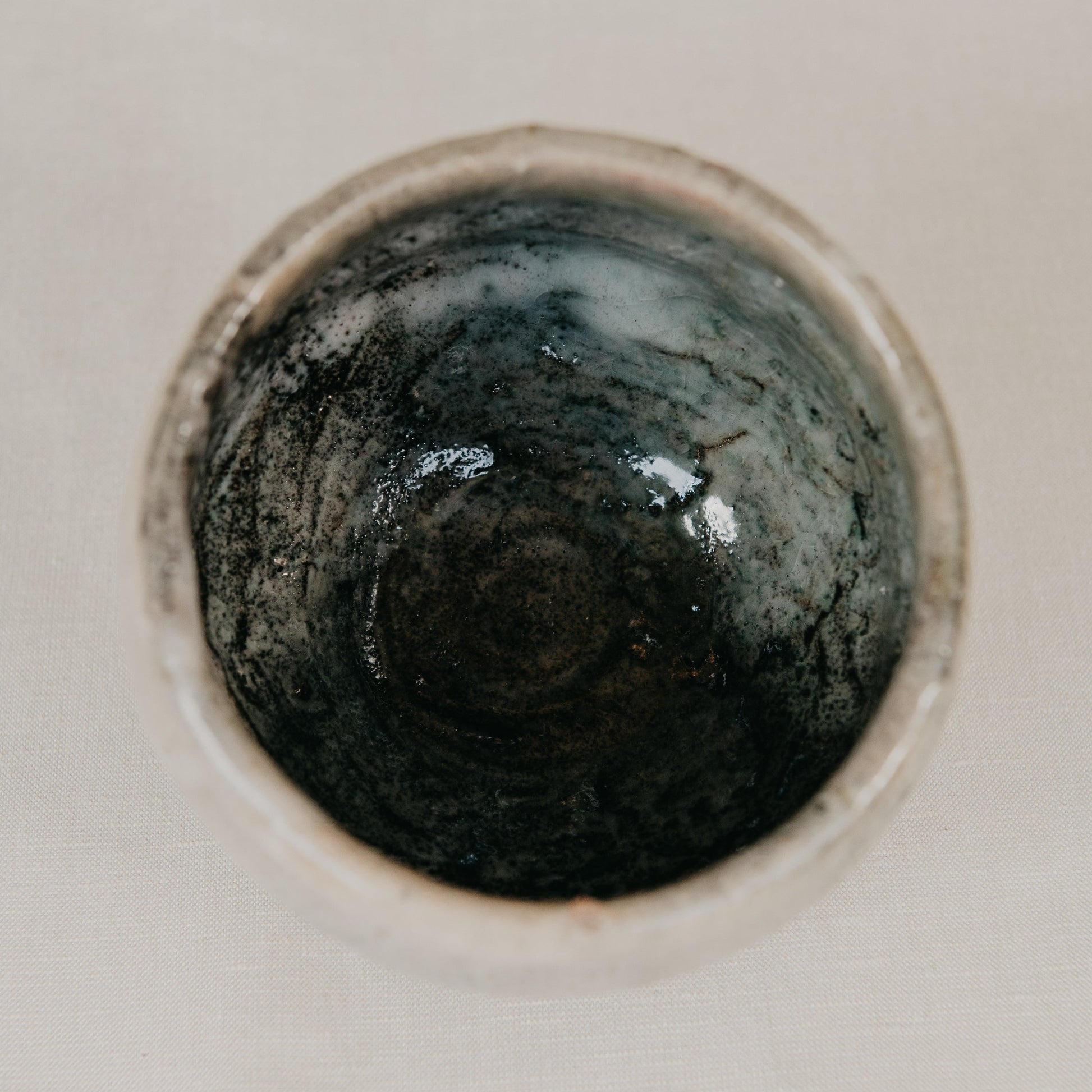 Close-up of a dark circular object on a light background