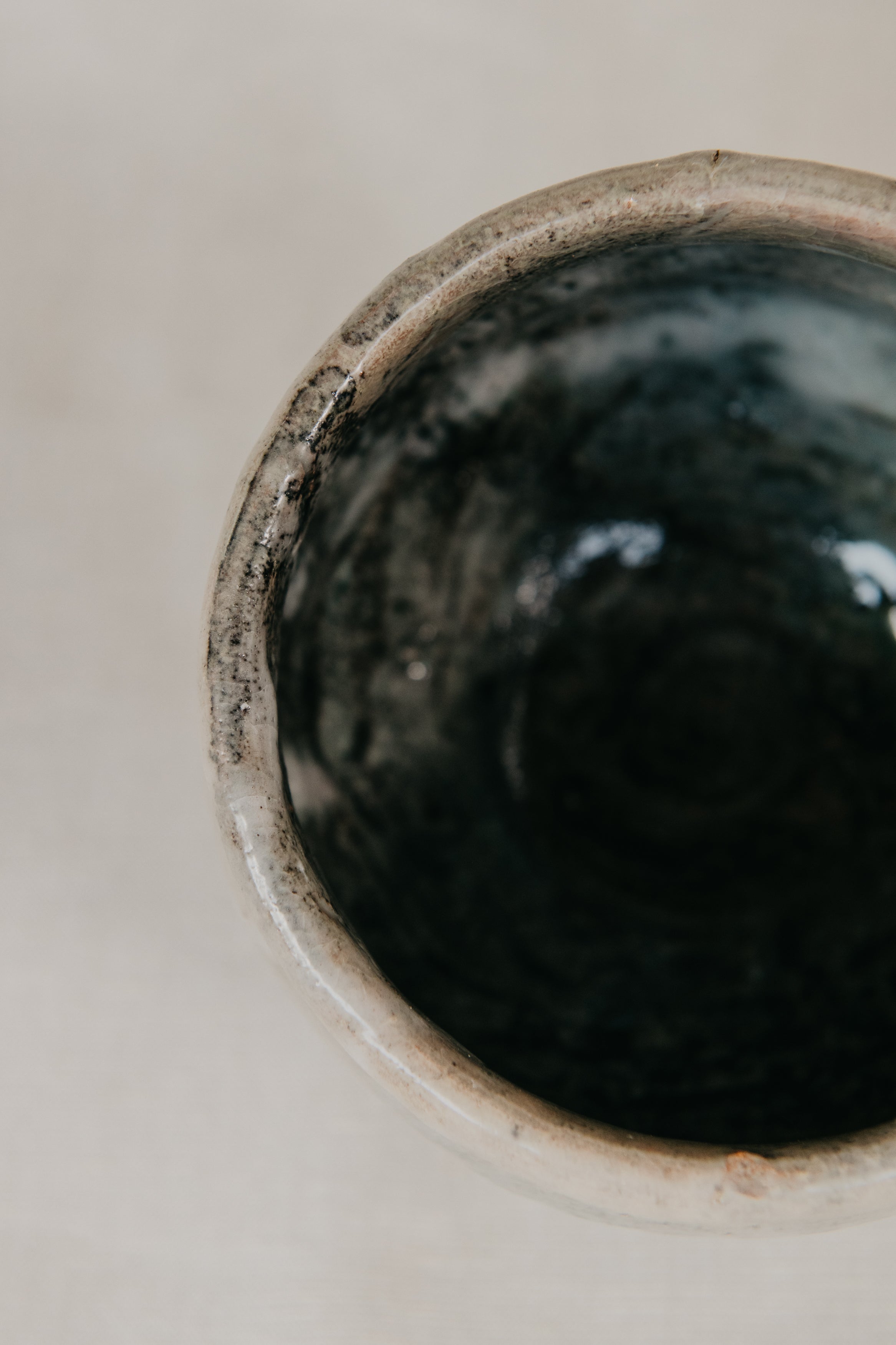 Close-up of a dark ceramic bowl on a light background