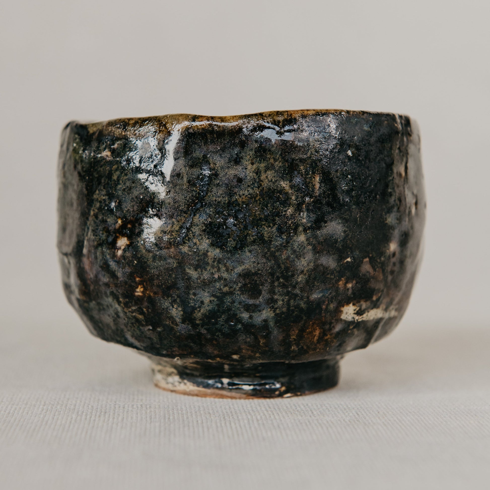 Black ceramic bowl on a light gray background