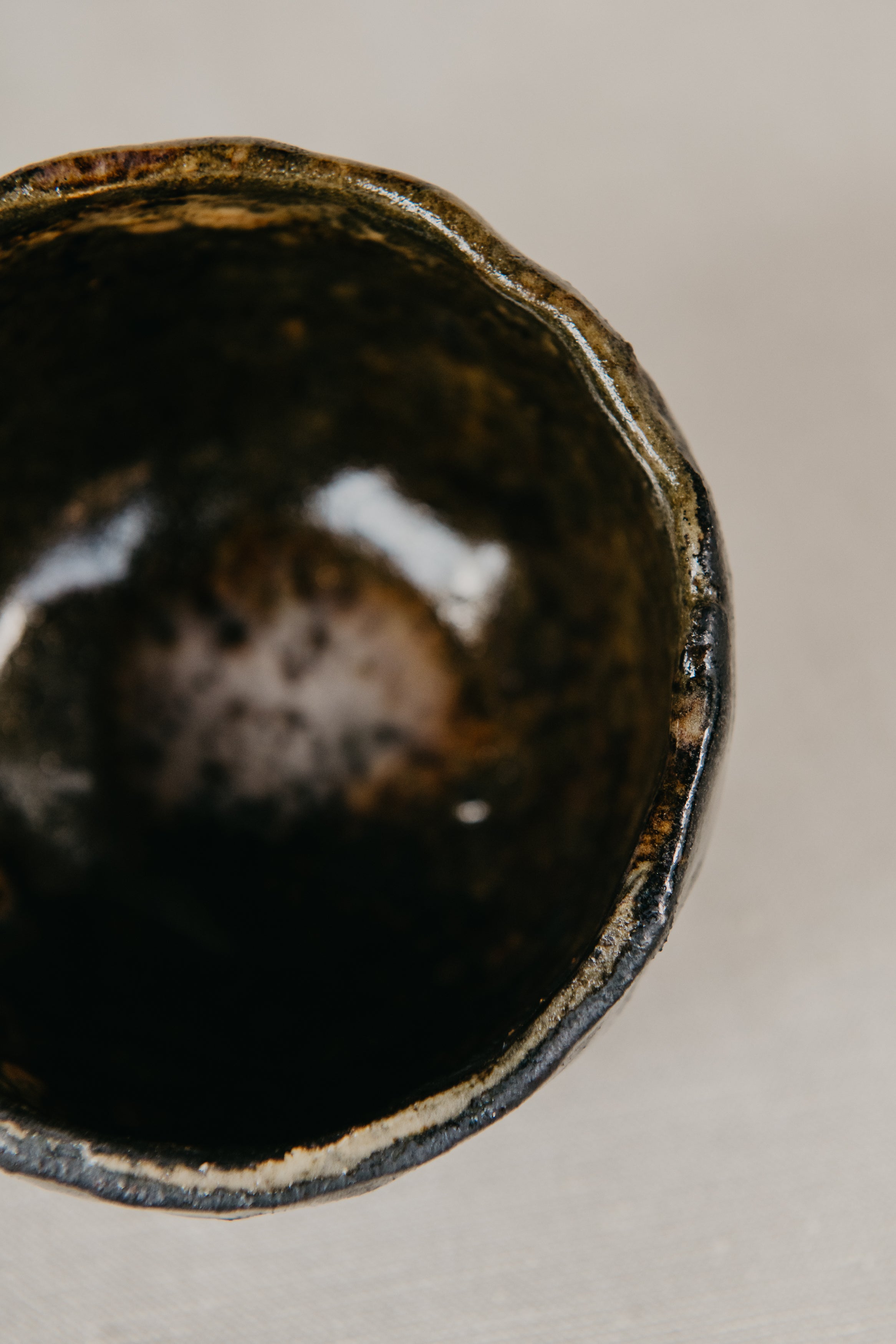 Close-up of a dark ceramic bowl on a light background