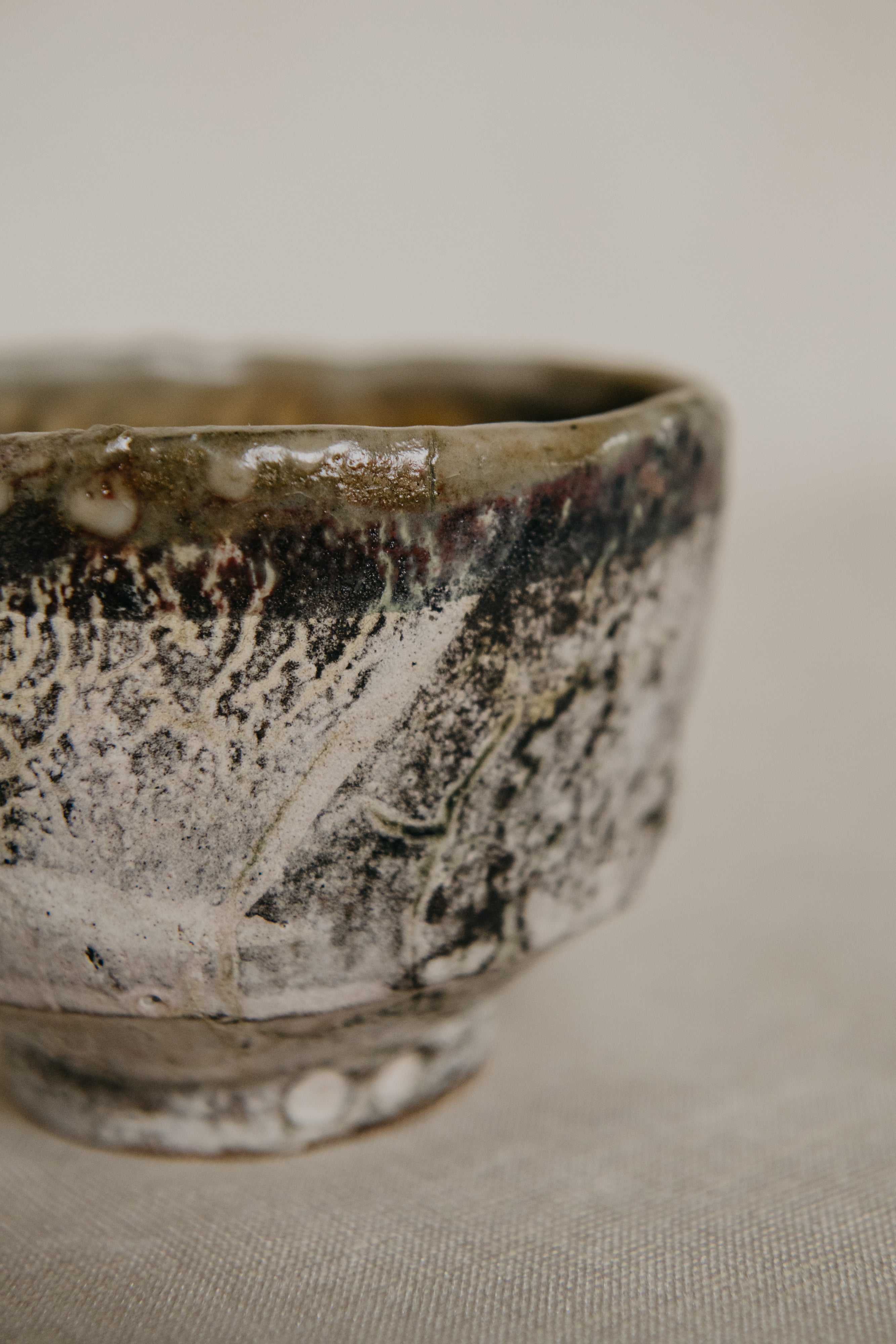 Close-up of a ceramic bowl with textured surface on a neutral background