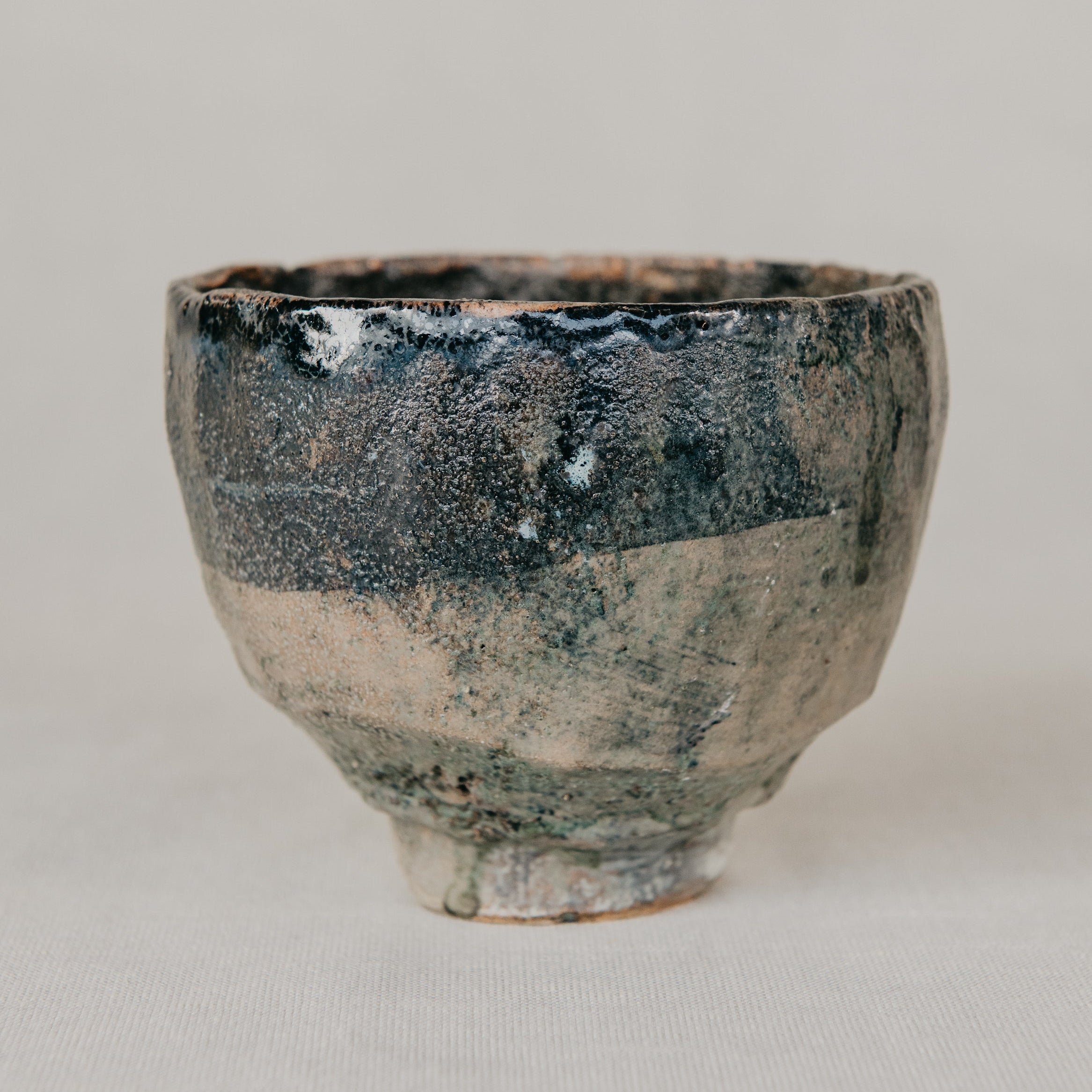 Ceramic cup with a textured surface on a plain background