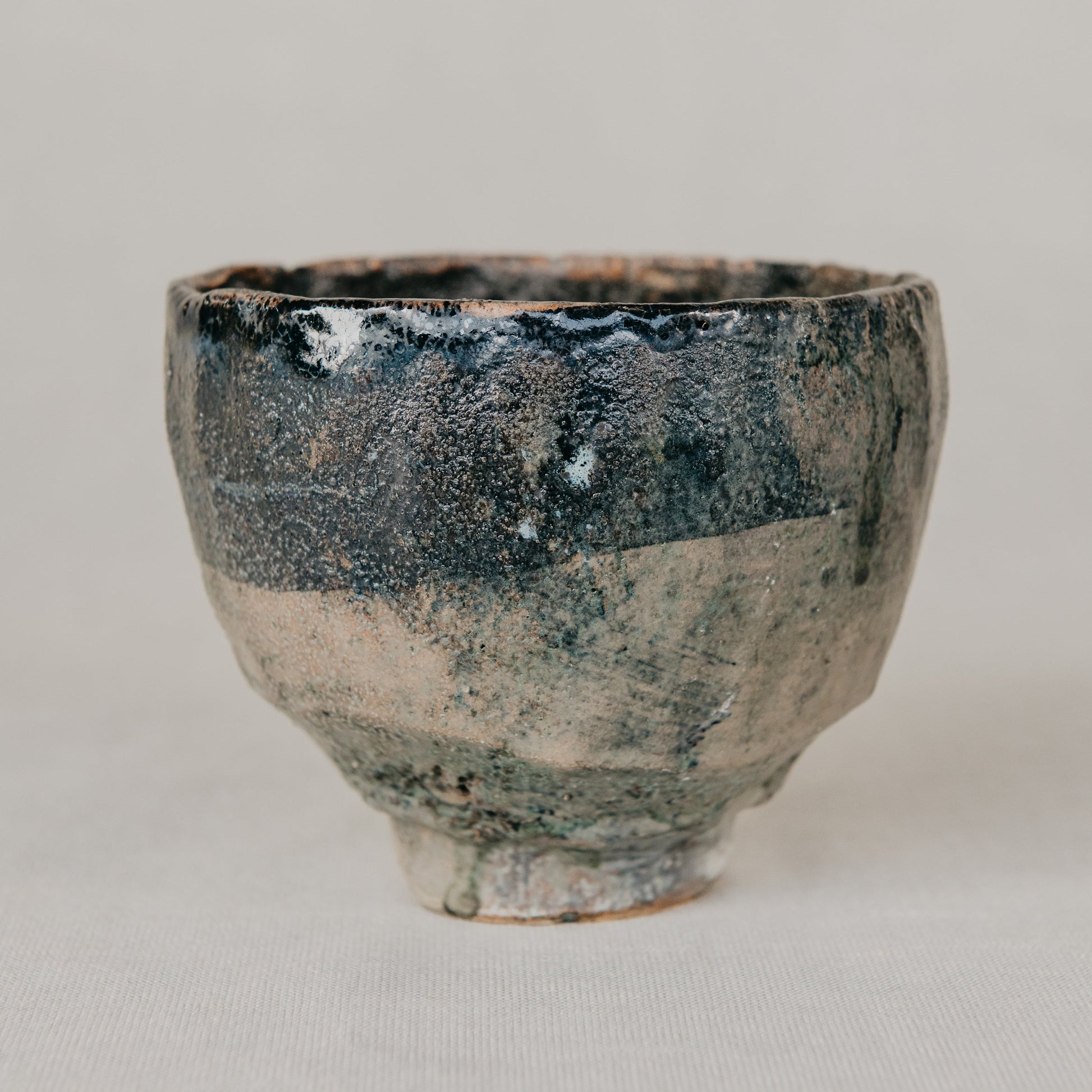 Ceramic cup with a textured surface on a plain background
