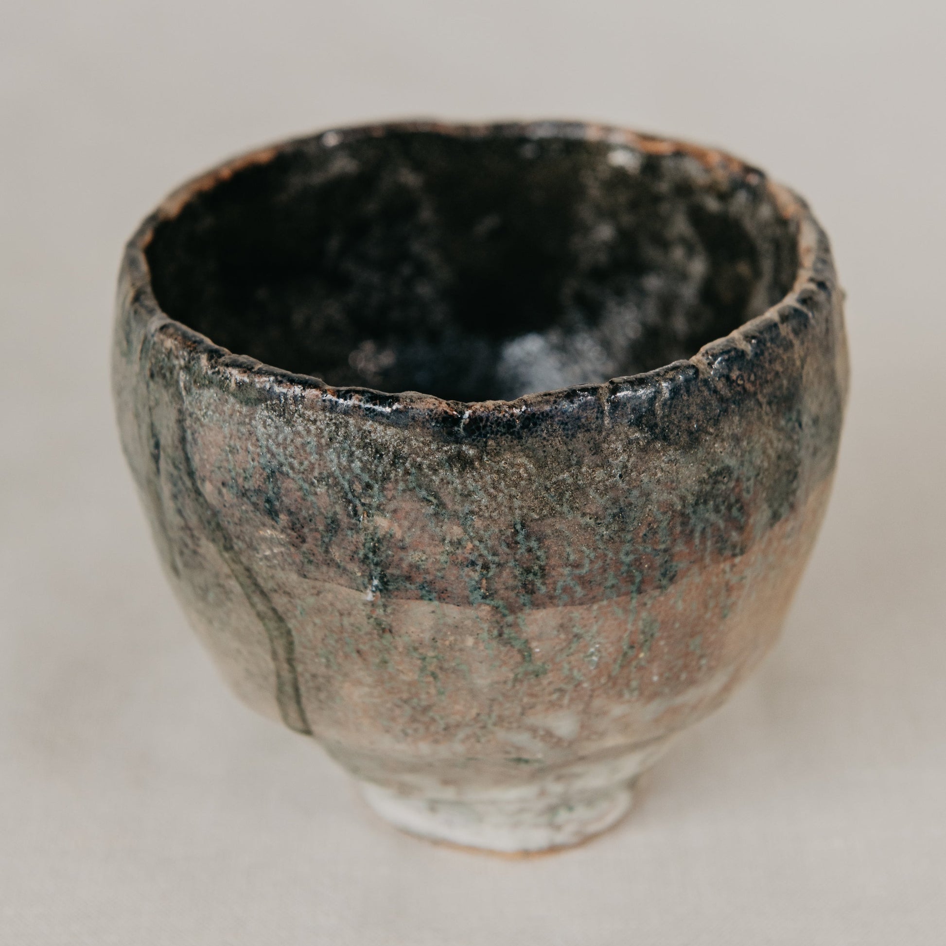 Ceramic cup with a textured surface on a plain background