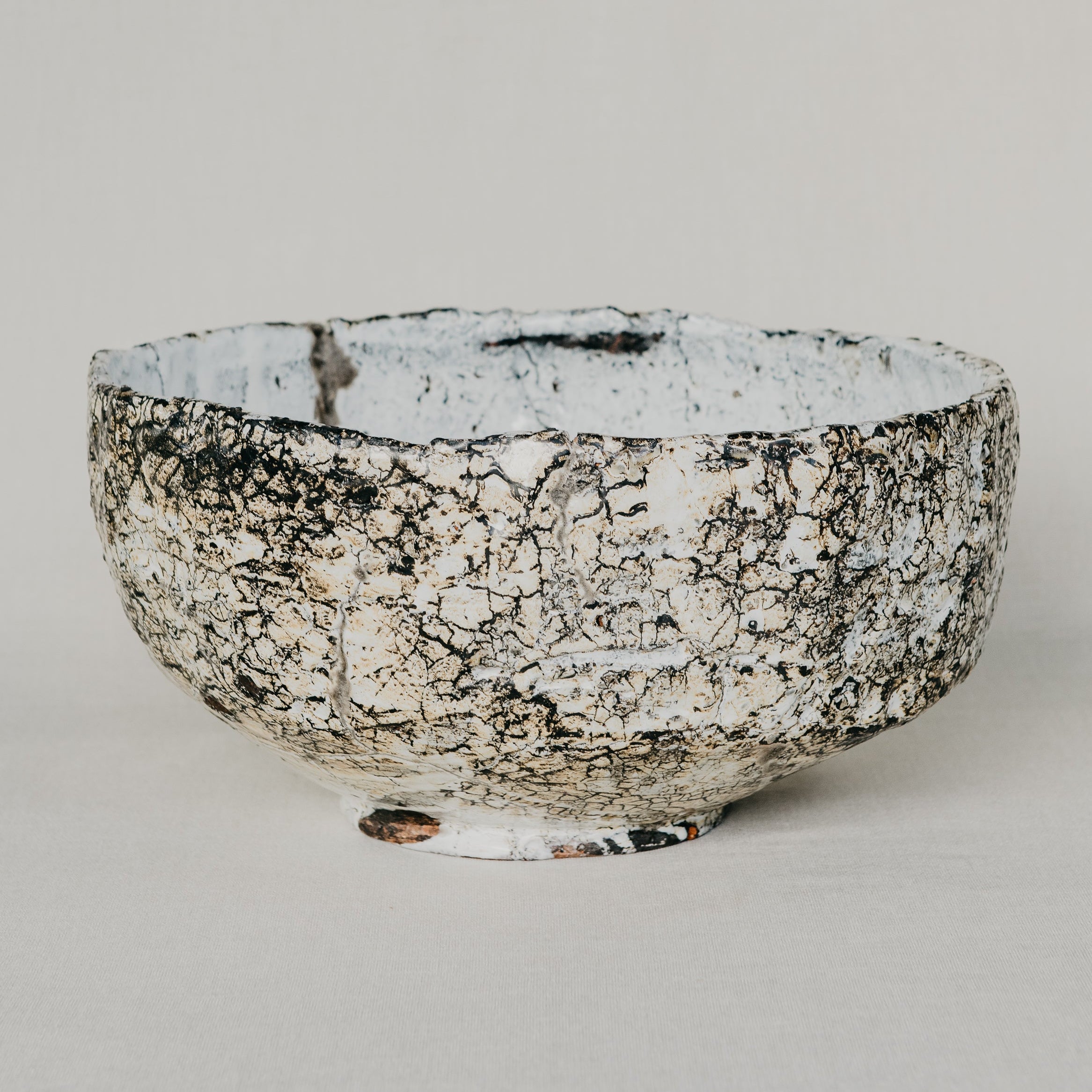 Ceramic bowl with textured surface on a light gray background