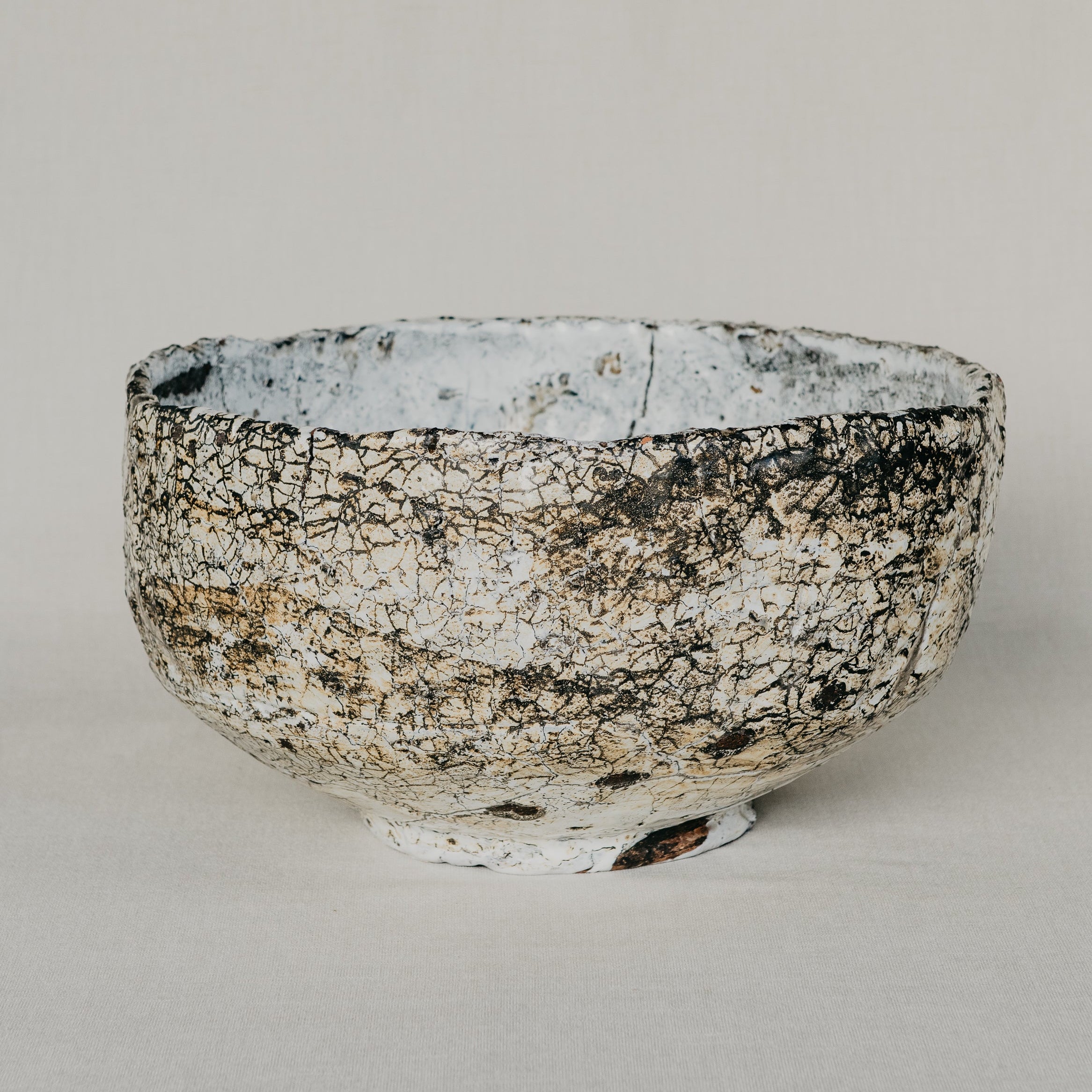 Ceramic bowl with textured surface on a plain background