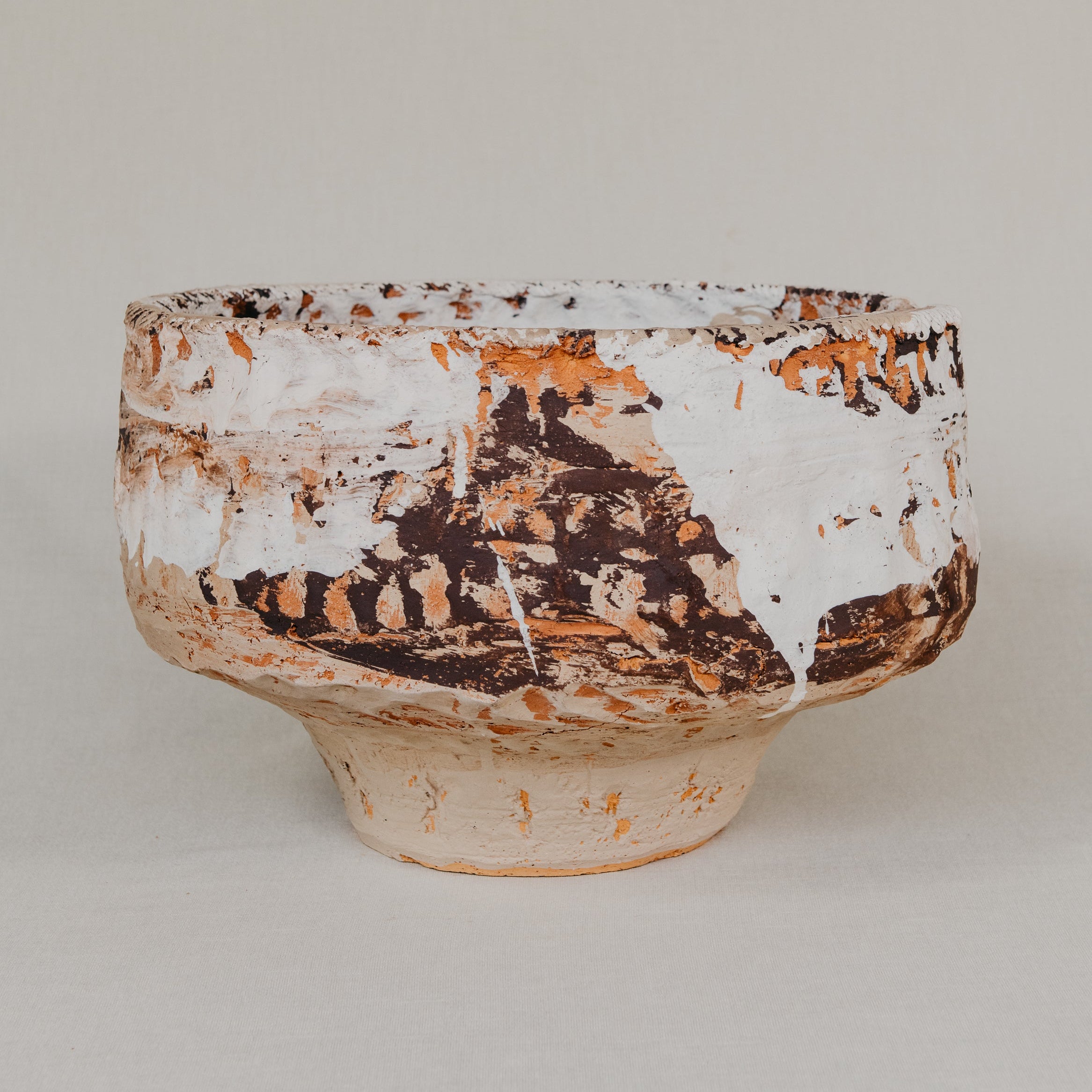 Ceramic bowl with textured surface on a plain background