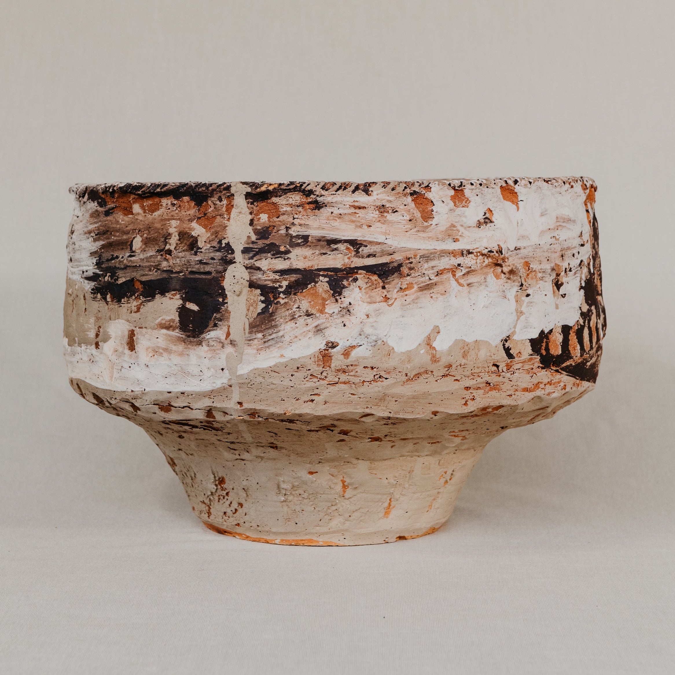 Round stone with a textured surface on a beige background