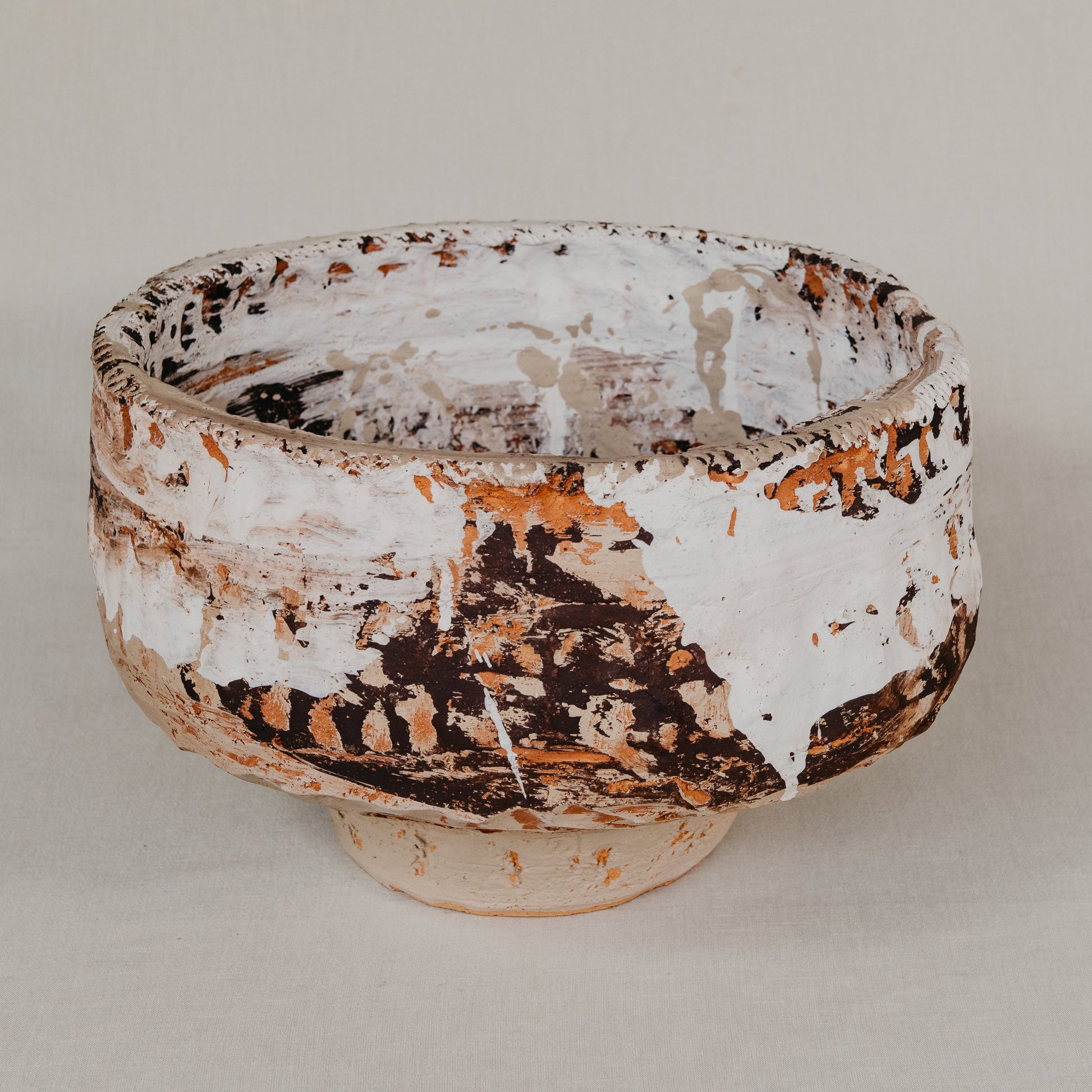 Ceramic bowl with textured surface on a plain background