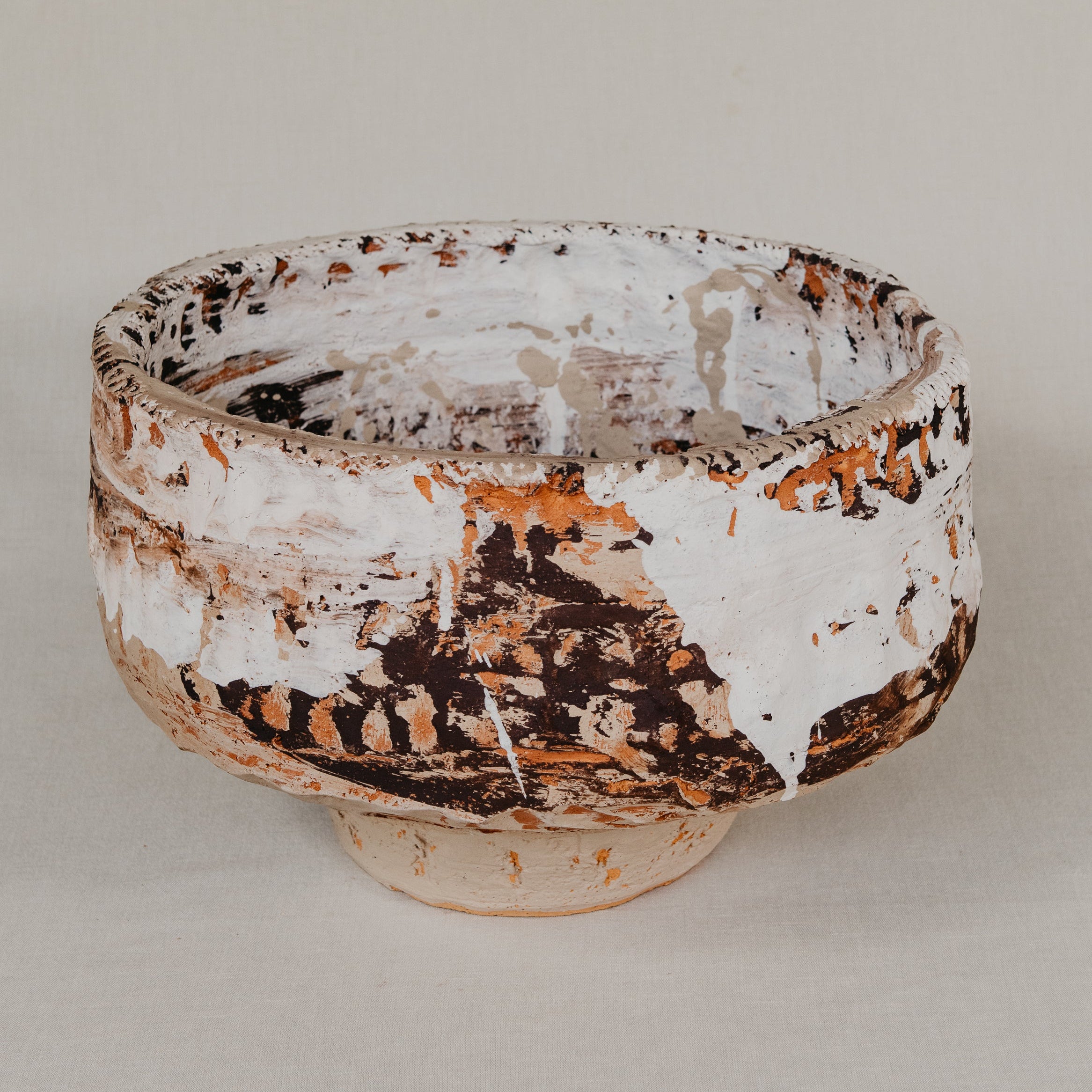 Ceramic bowl with textured surface on a plain background