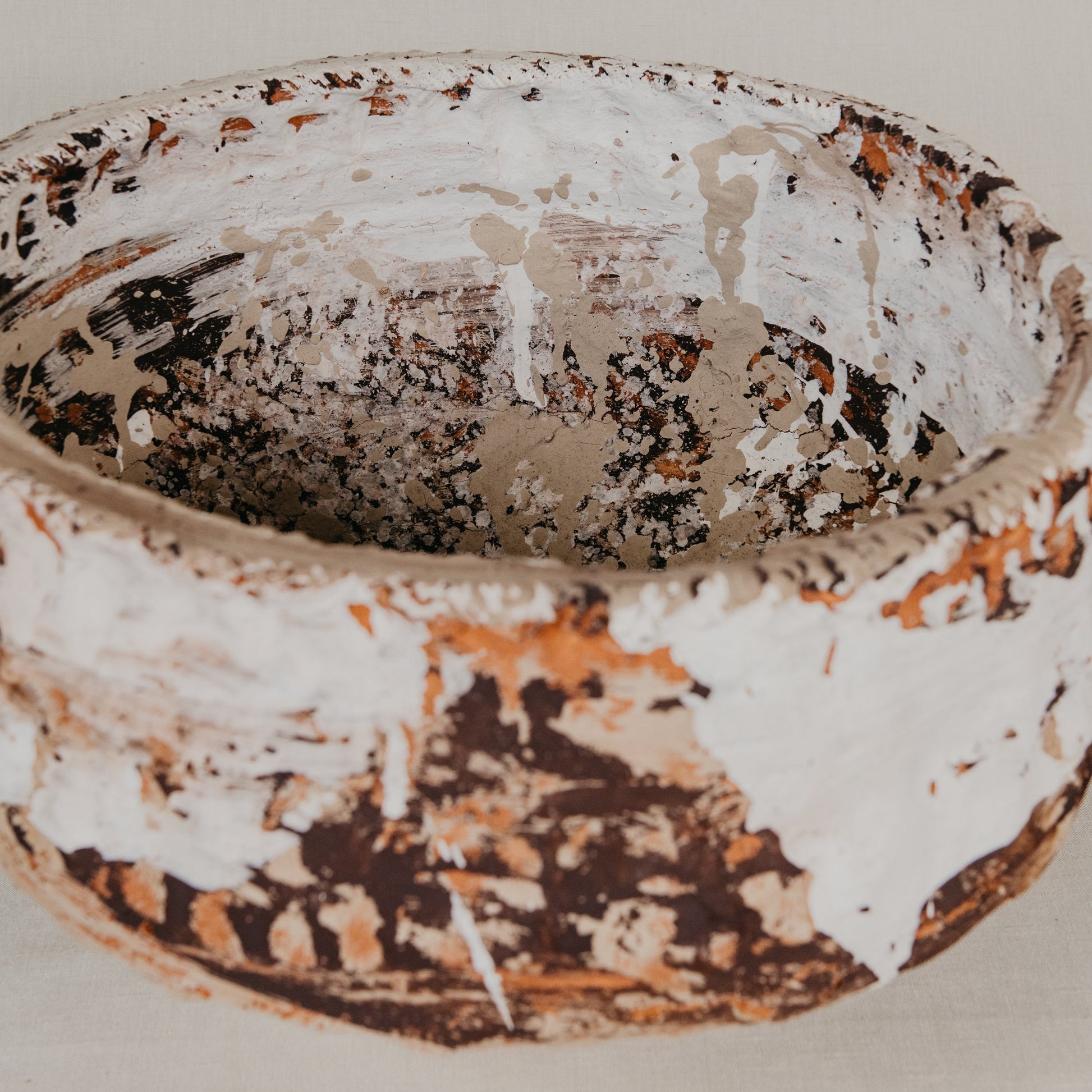 Vintage ceramic bowl with a textured surface on a plain background