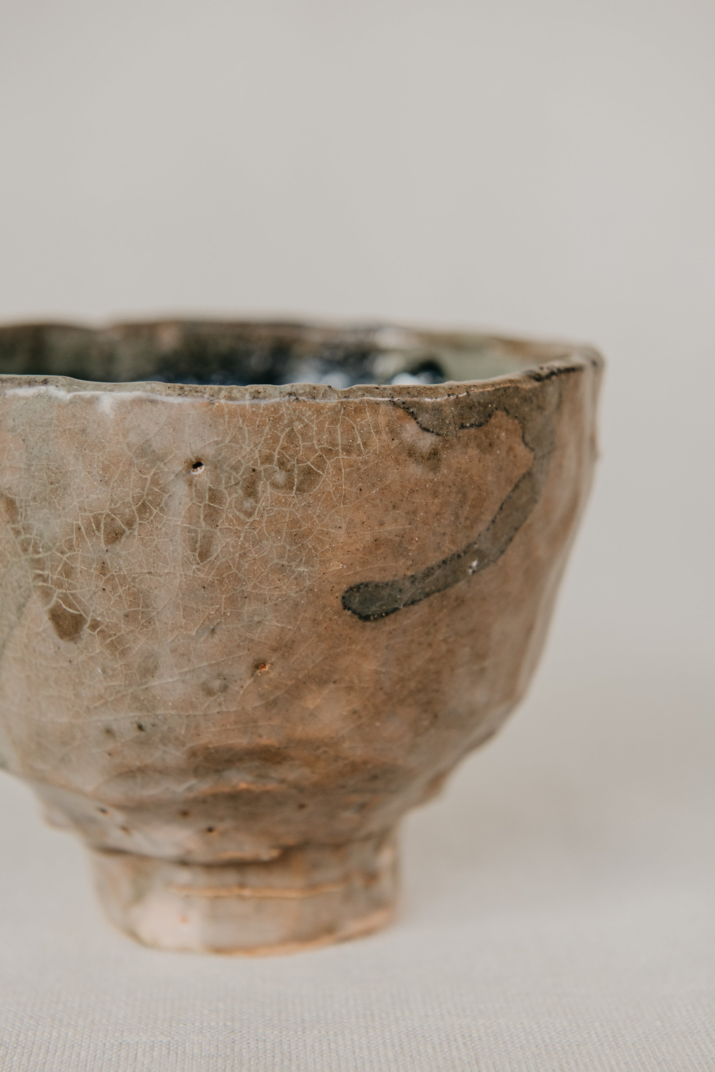 Ceramic cup with a textured surface on a neutral background