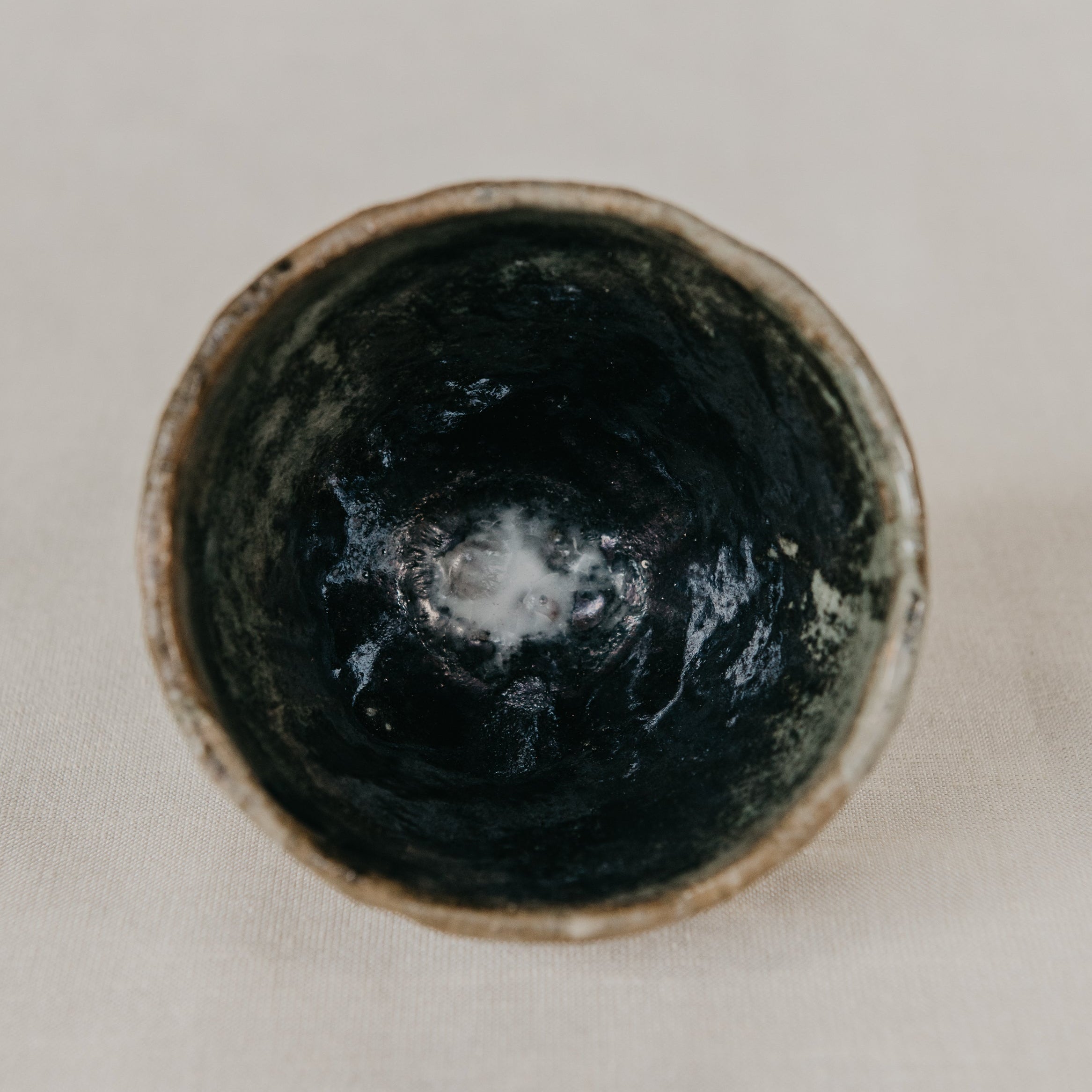 Black ceramic bowl on a light beige background