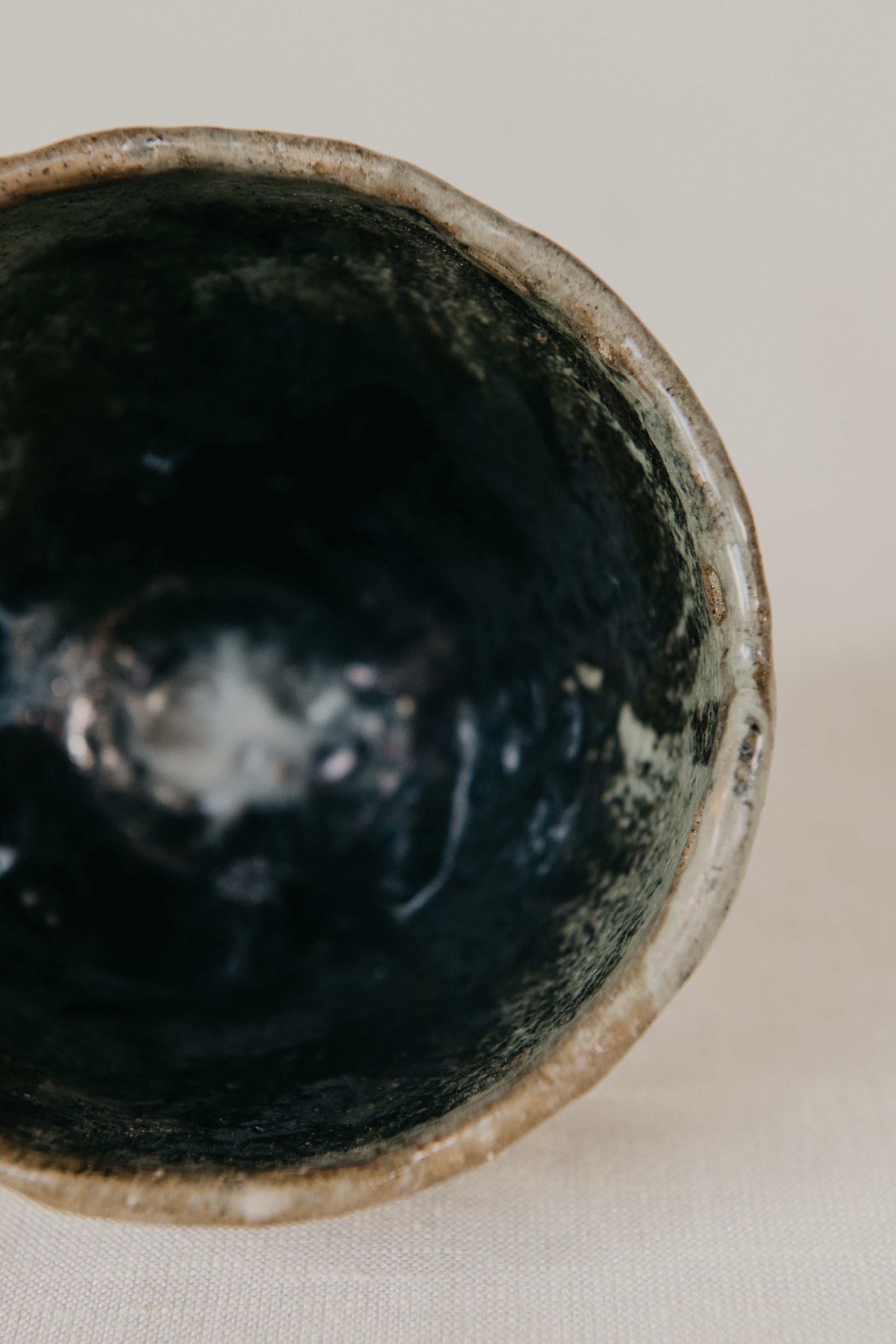 Close-up of a dark ceramic bowl on a light background