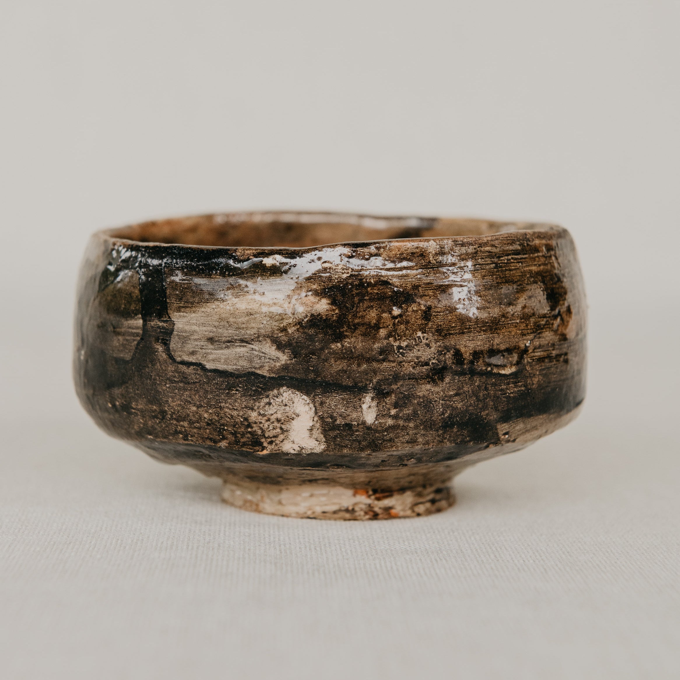 Brown ceramic bowl on a light gray background