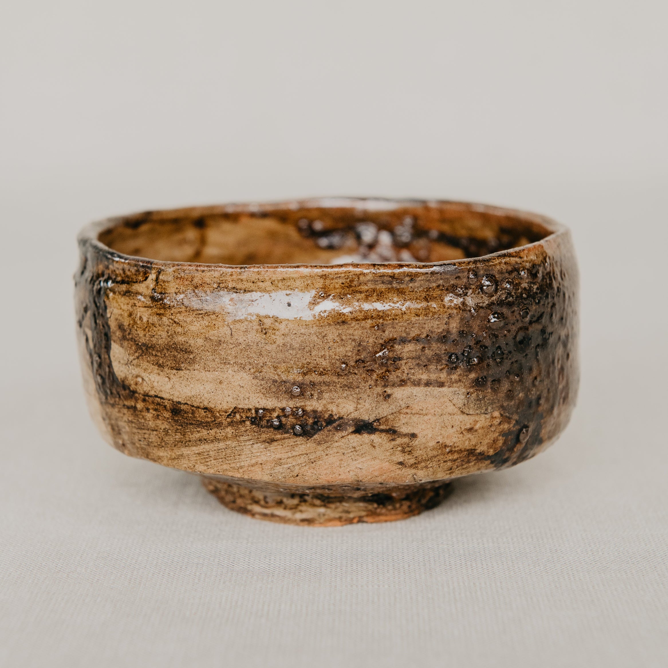 Brown ceramic bowl on a light gray background