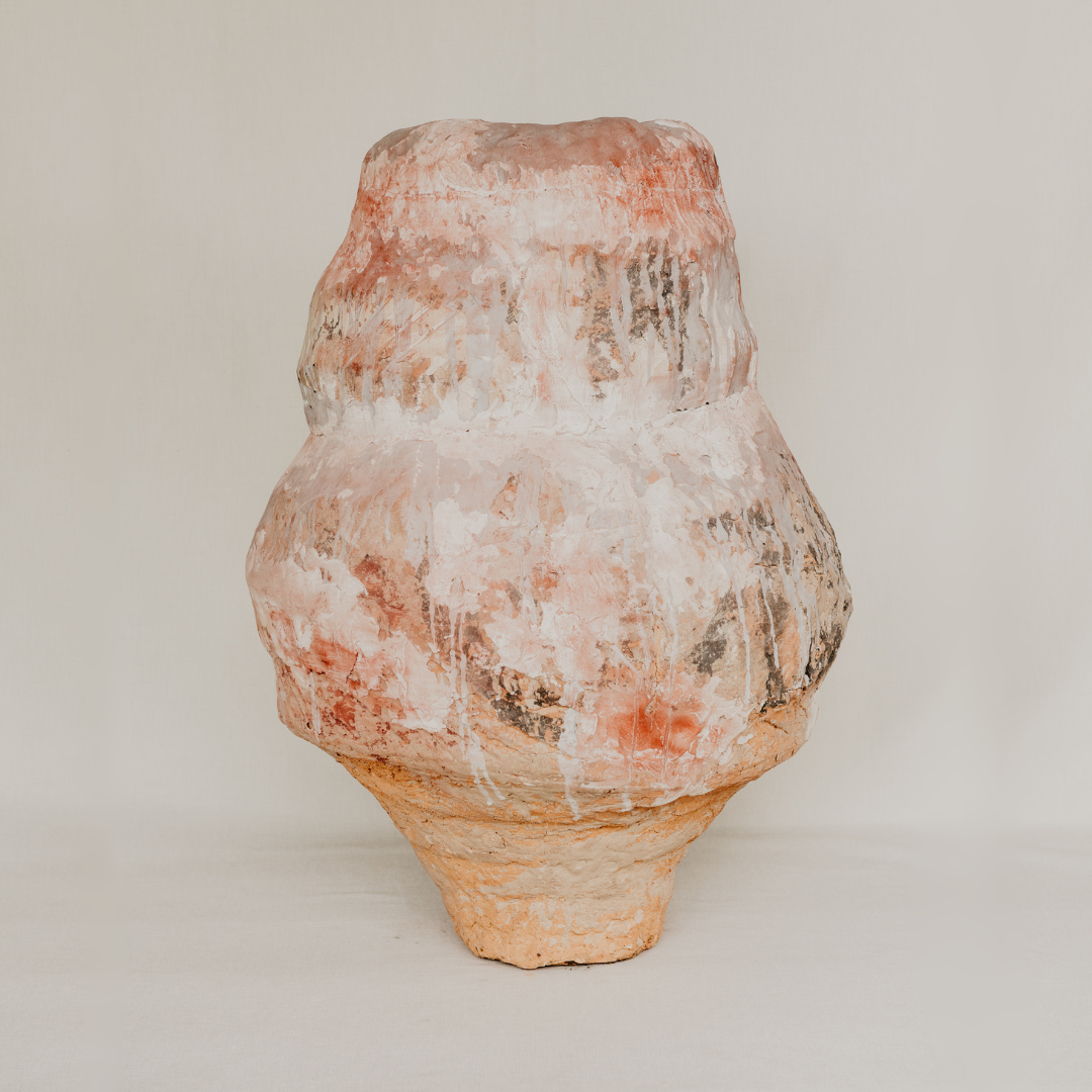 Vintage terracotta vase with a textured surface on a plain background