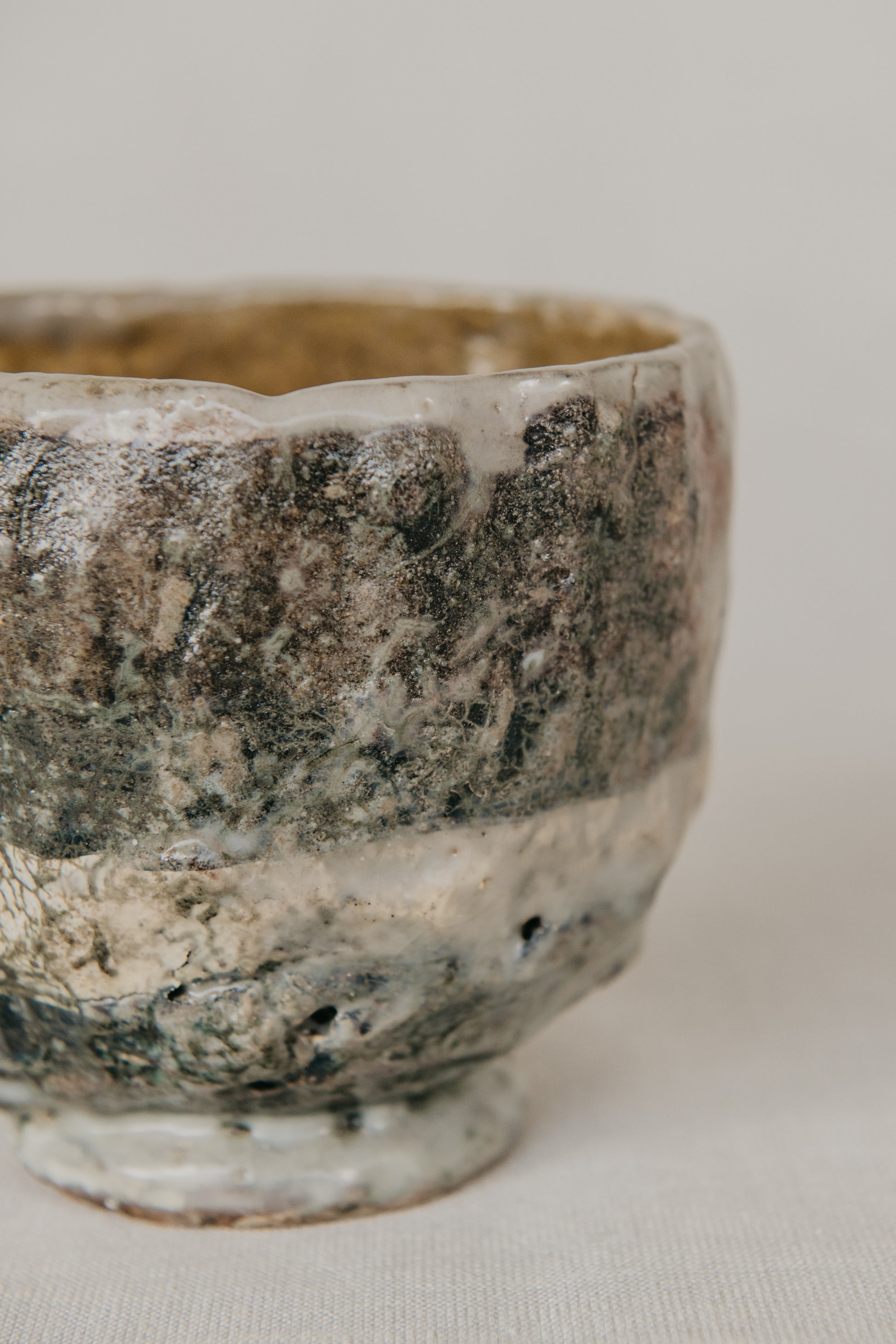 Vintage ceramic bowl with a textured surface on a neutral background